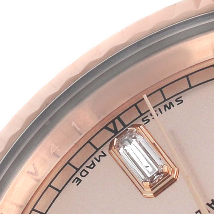 The image shows a close-up of the dial and bezel of a Rolex President 118235 Men's Rose Gold Pink Dial model, featuring a gem marker and part of the VI marker.