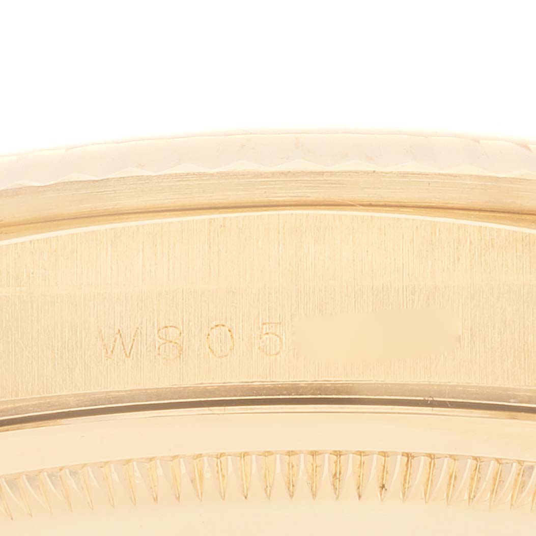 The image shows a close-up of the side view of a Rolex President 18238 Men
s Yellow Gold Black Dial 18238 Men
s Yellow Gold Black Dial model, highlighting the serial number engraving on the case.