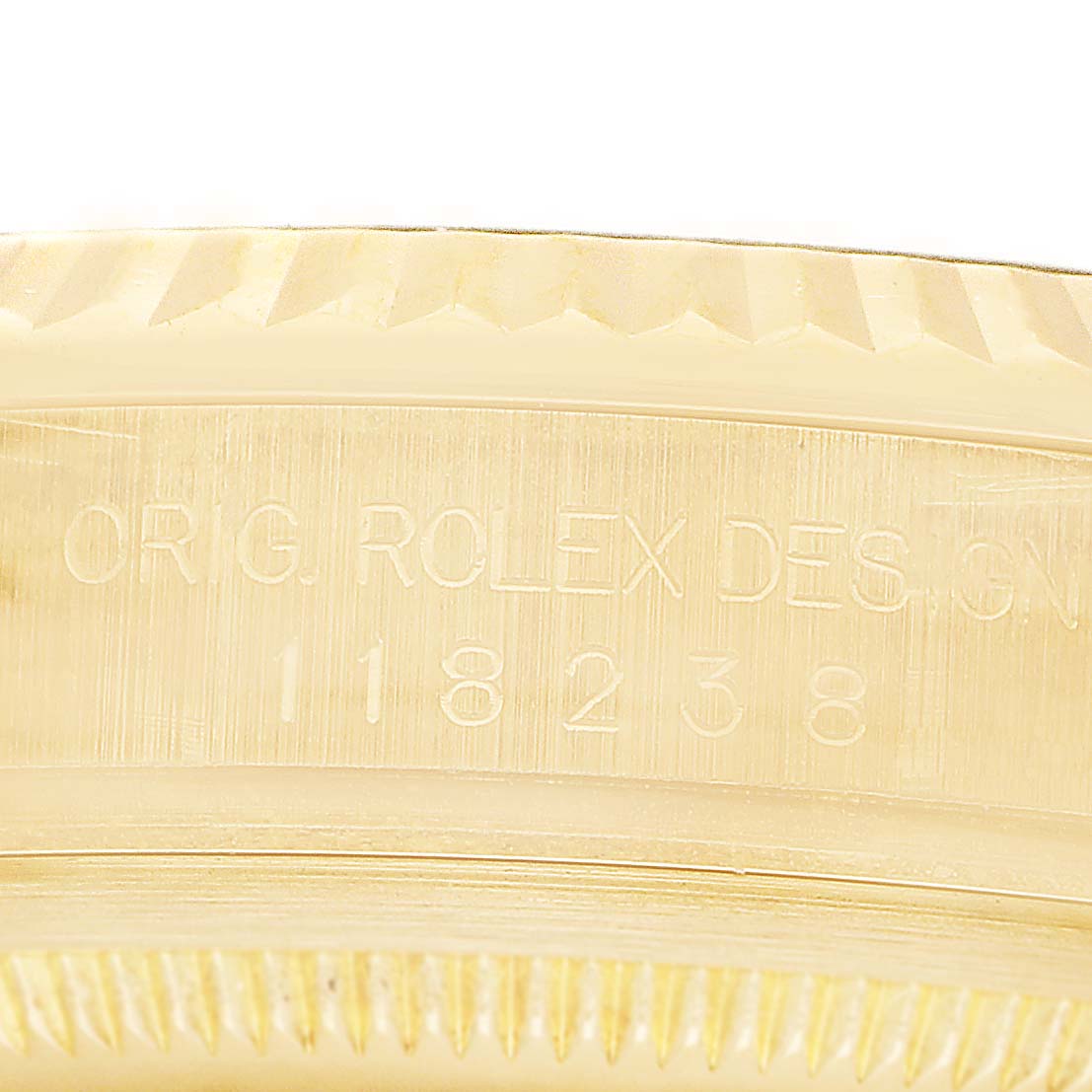 The image shows a close-up of the side of a Rolex President 118238 Men's Yellow Gold Champagne Dial model, displaying design engraving and part of the fluted bezel.