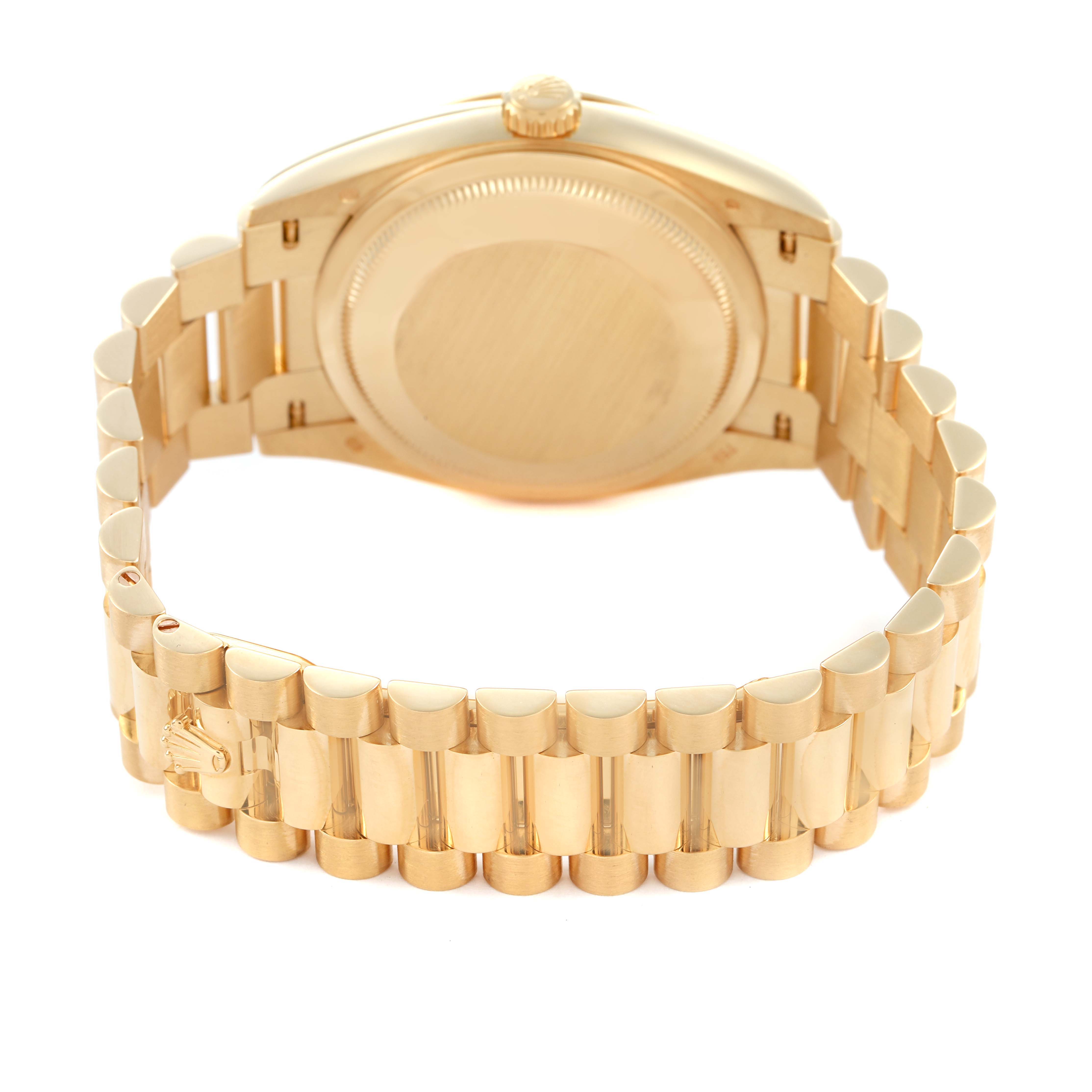 The image shows the back and bracelet of a Rolex President 128238 Men's Yellow Gold Grey Dial model, highlighting its gold finish and clasp.