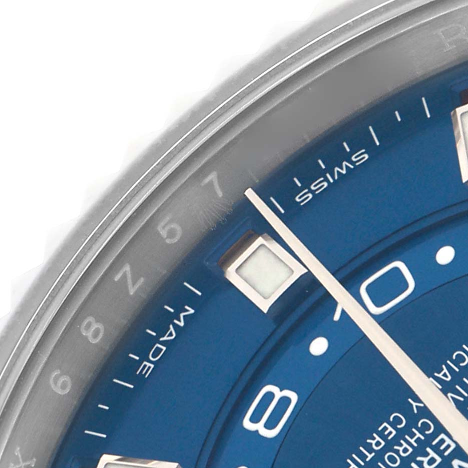 The image shows a close-up of the Rolex Sky-Dweller 326934 Men
s Stainless Steel Blue Dial
s blue dial, focusing on the hour markers and partial bezel.