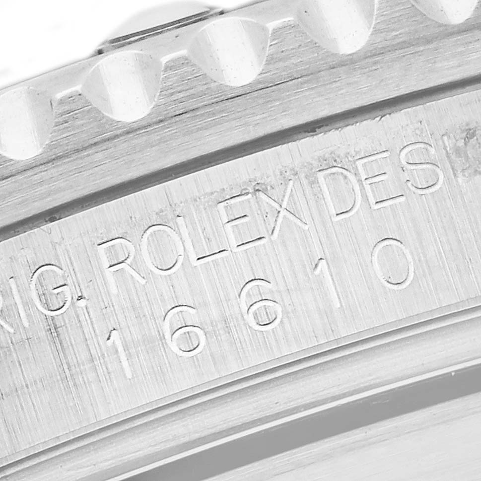 This close-up image shows the engraved serial number on the side of the bezel of a Rolex Submariner 16610 Men's Stainless Steel Black Dial 16610 Men's Stainless Steel Black Dial model watch.