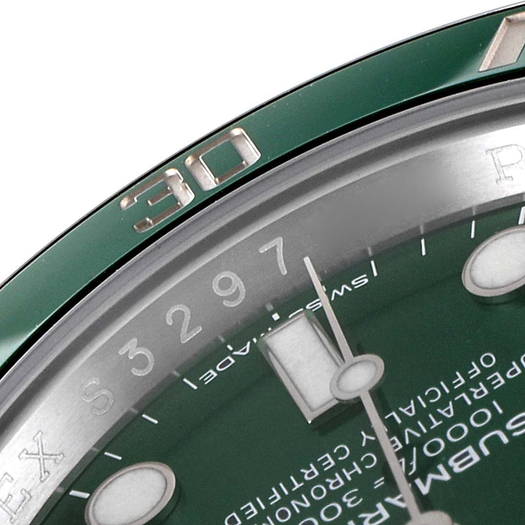 The image shows a close-up of the dial and bezel of a Rolex Submariner 116610LV Men
s Stainless Steel Green Dial 116610LV Men
s Stainless Steel Green Dial watch with a green background and the "30" marker visible.