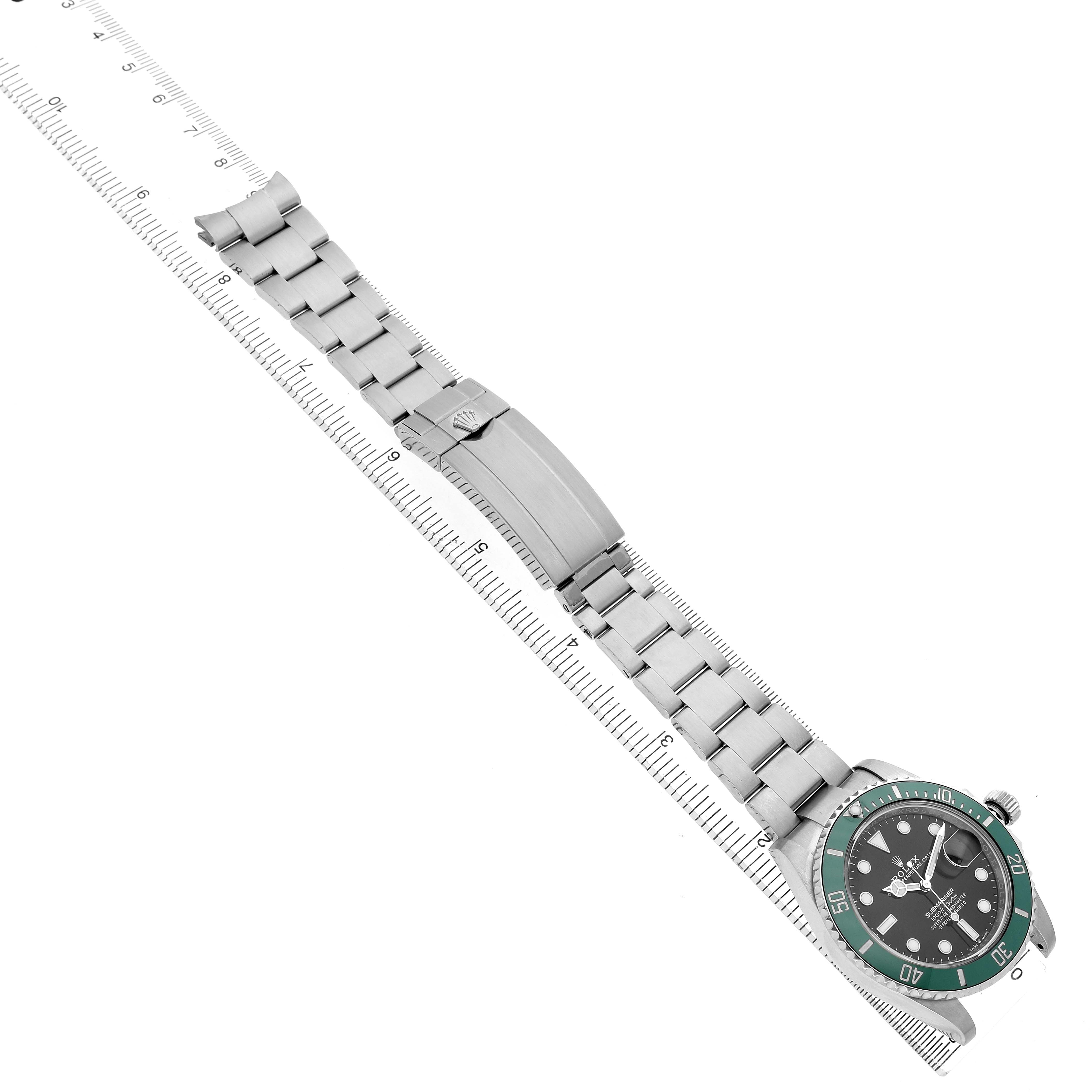 The Rolex Submariner 126610LV Men's Stainless Steel Black Dial watch is shown laid flat with its bracelet aligned along a ruler, highlighting the clasp and bezel.