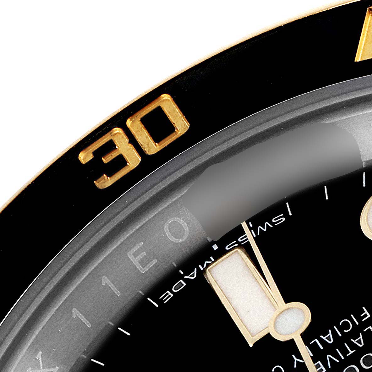 The image shows a close-up of the bezel and part of the dial of a Rolex Submariner 116613 Men
s Steel and Gold (two tone) Black Dial 116613 Men
s Steel and Gold (two tone) Black Dial watch, including the "SWISS MADE" text and part of the minute hand.