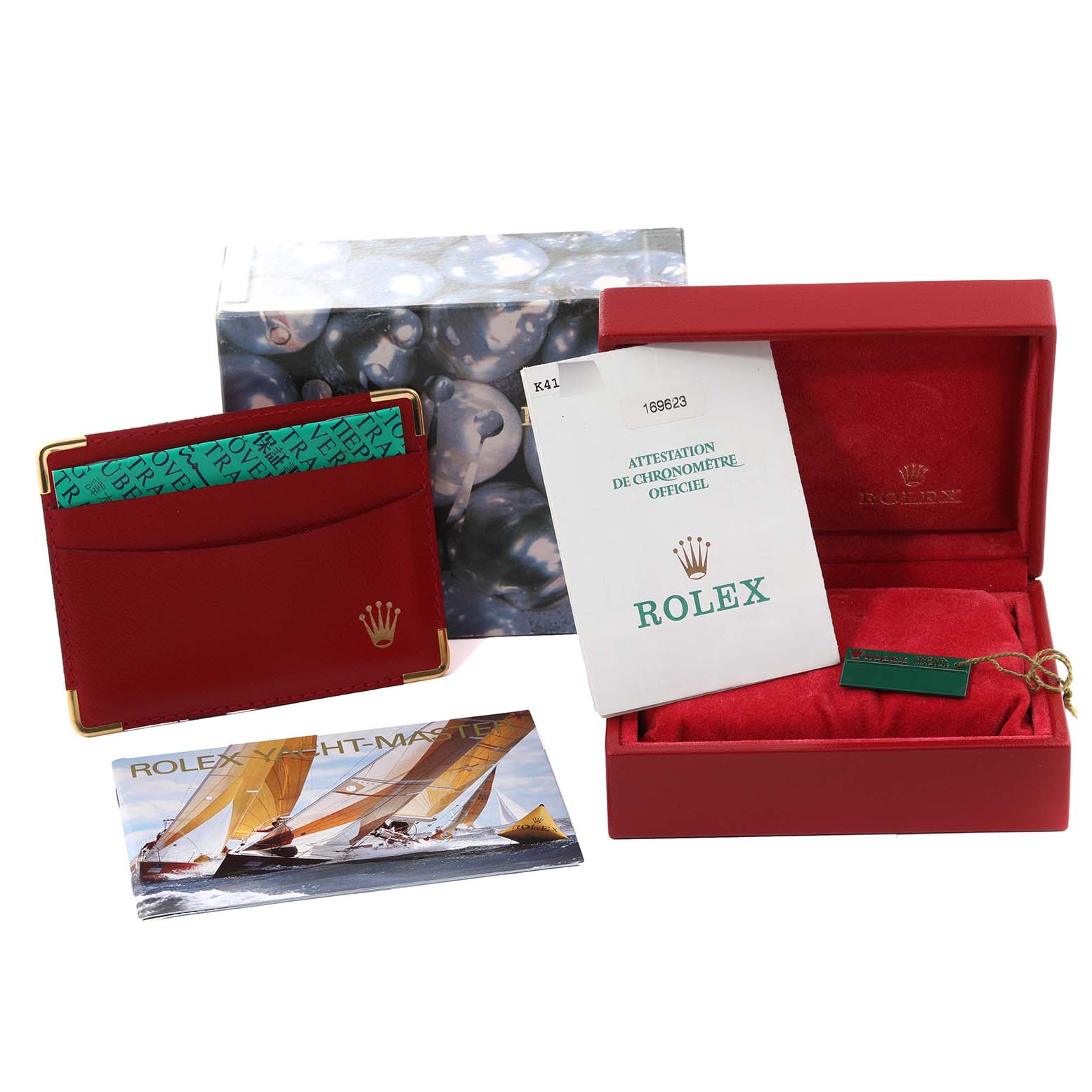 This image shows the box, manual, warranty card holder, and attestation document for the Rolex Yacht-Master 169623 Women's Steel and Gold (two tone) White Dial 169623 Women's Steel and Gold (two tone) White Dial watch.