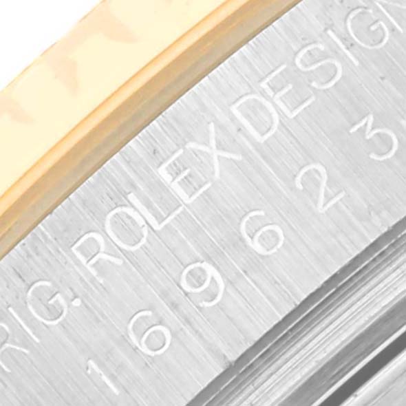 The image shows an extreme close-up of the side of the Yacht-Master model by Rolex, focusing on the engraved serial number and part of the bezel.