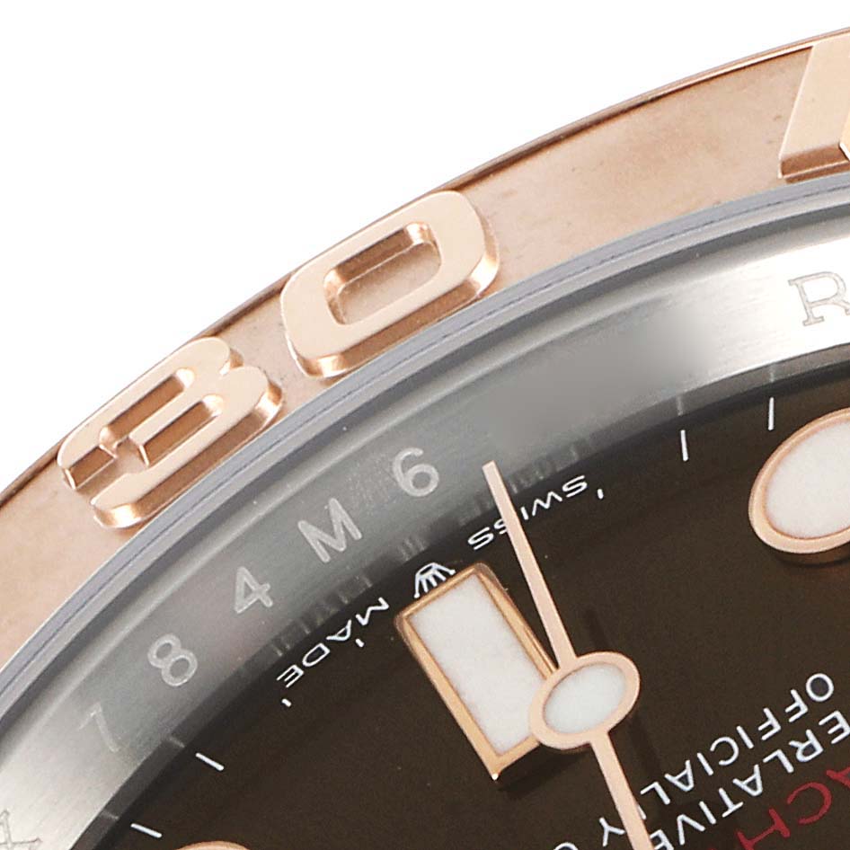 The image shows a close-up of the bezel and part of the dial with the minute and hour hands of a Rolex Yacht-Master 126621 Men's Stainless Steel Brown Dial 126621 Men's Stainless Steel Brown Dial watch.