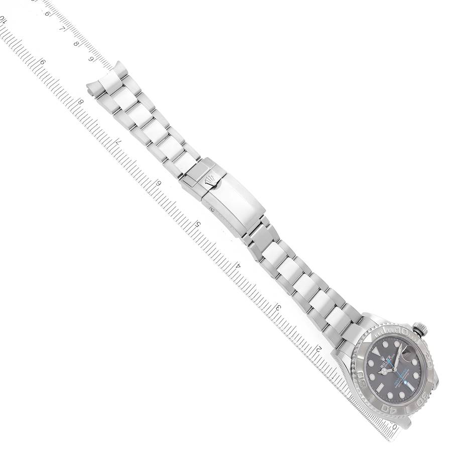 The Rolex Yacht-Master 126622 Men's Stainless Steel Grey Dial watch is shown at an angle displaying its face, bracelet, and clasp alongside a ruler.