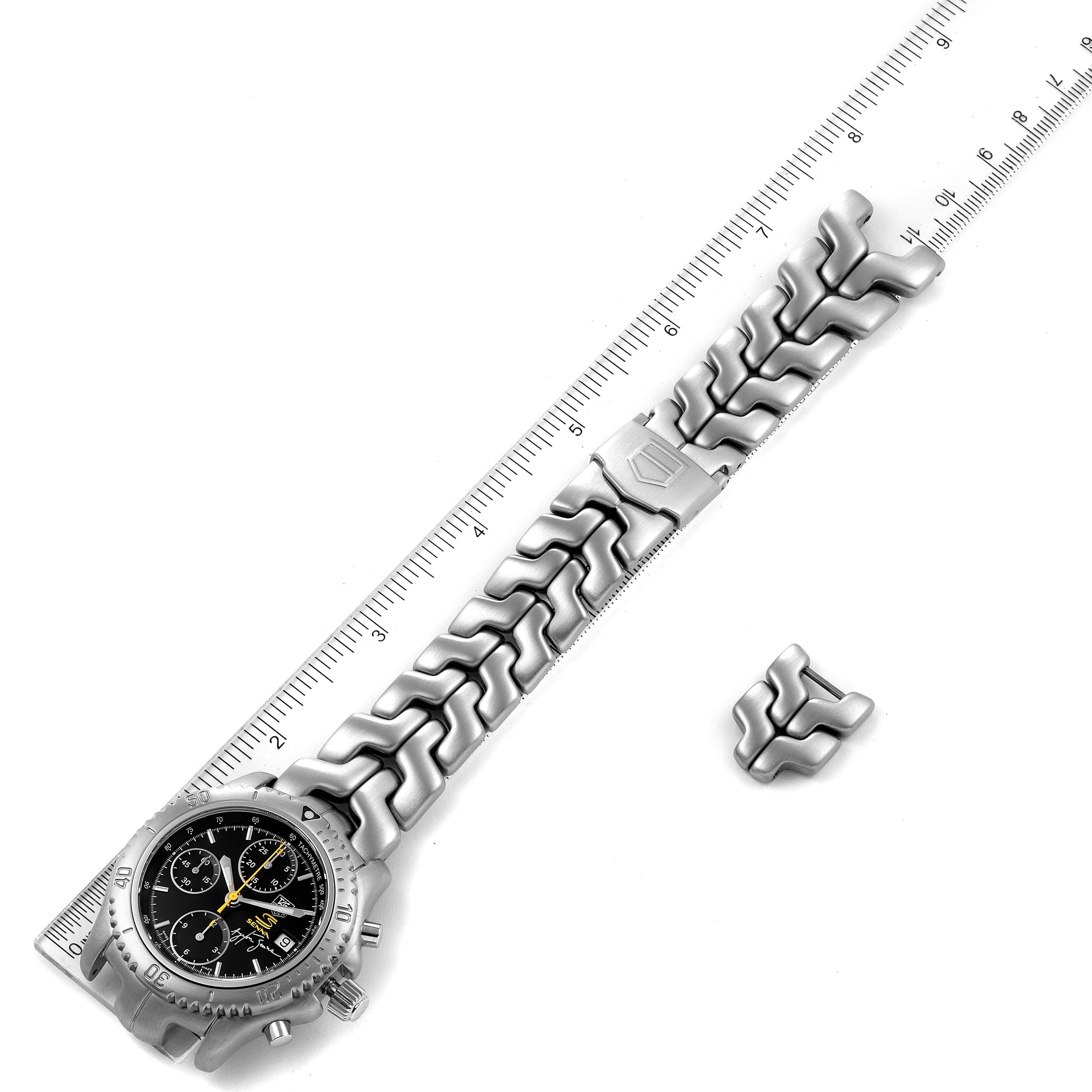 The Tag Heuer Link CT2115 Men
s Stainless Steel Black Dial CT2115 Men
s Stainless Steel Black Dial model watch is shown flat with its band extended beside a ruler, along with a spare link accessory.