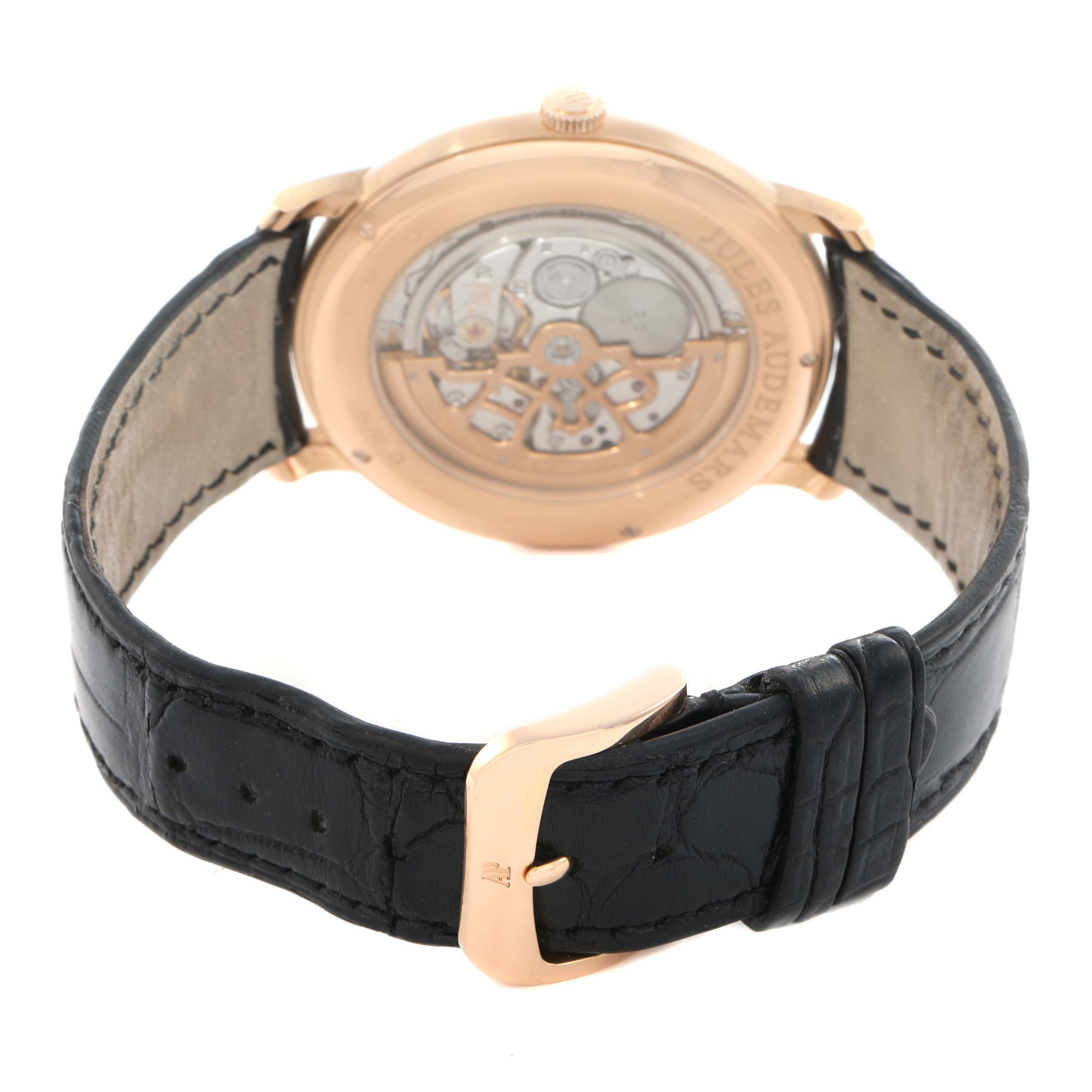 The image shows the back of the Audemars Piguet Jules 15180R Men's Rose Gold Black Dial watch, highlighting its movement and black leather strap with a gold buckle.