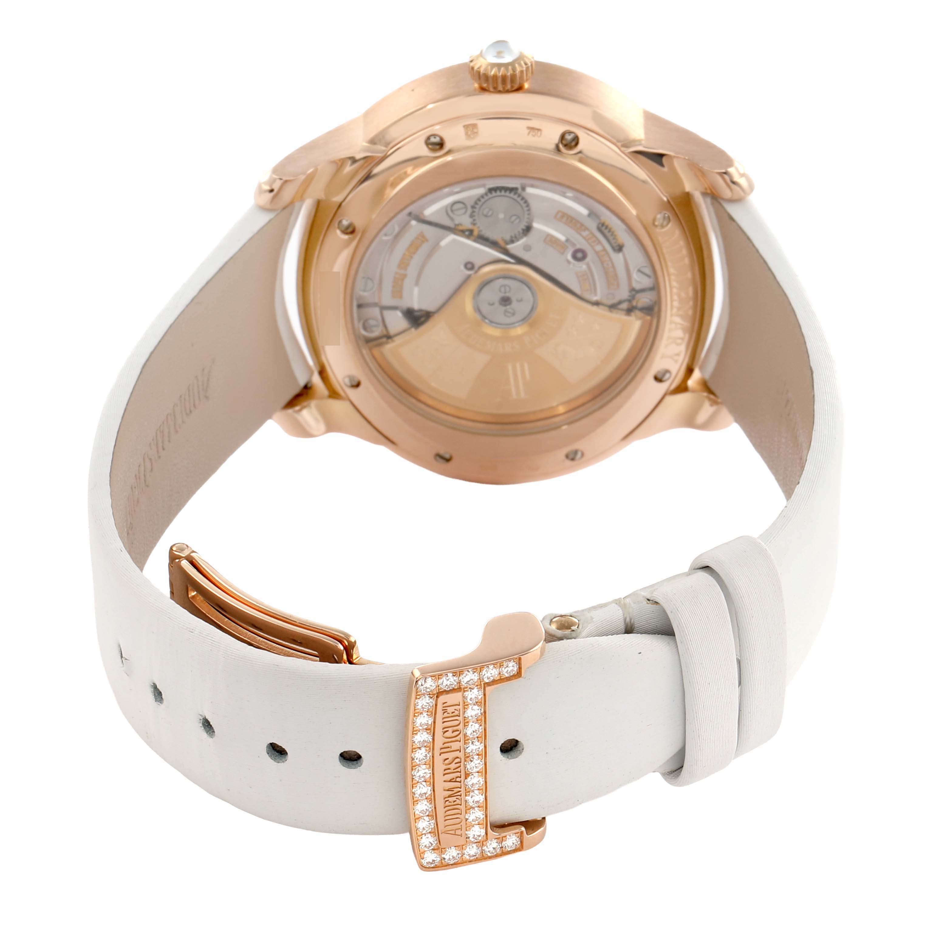 The image shows a rear view of the Audemars Piguet Millenary 77315OR Women's Rose Gold Mother of Pearl Dial watch, highlighting the case back and white leather strap with a gem-set clasp.