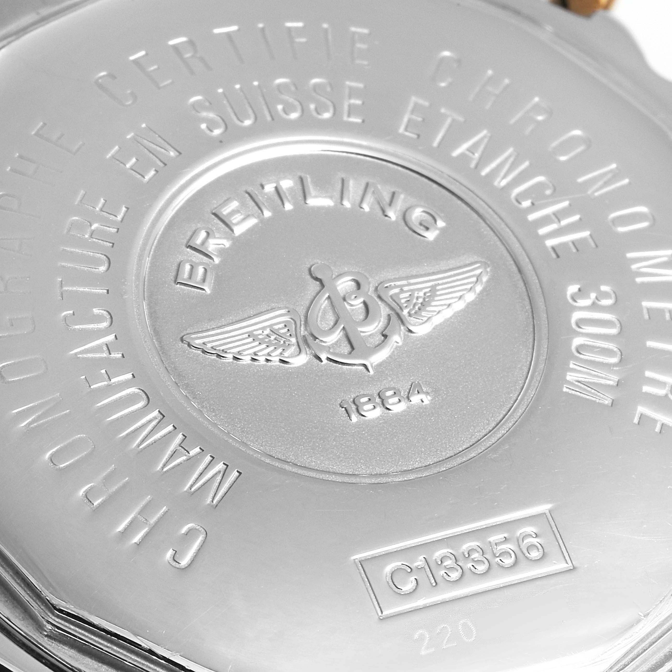 The image shows the back case of a Breitling Chronomat C13356 Men's Steel and Gold (two tone) Silver Dial C13356 Men's Steel and Gold (two tone) Silver Dial watch, featuring engraved details and the brand's logo.