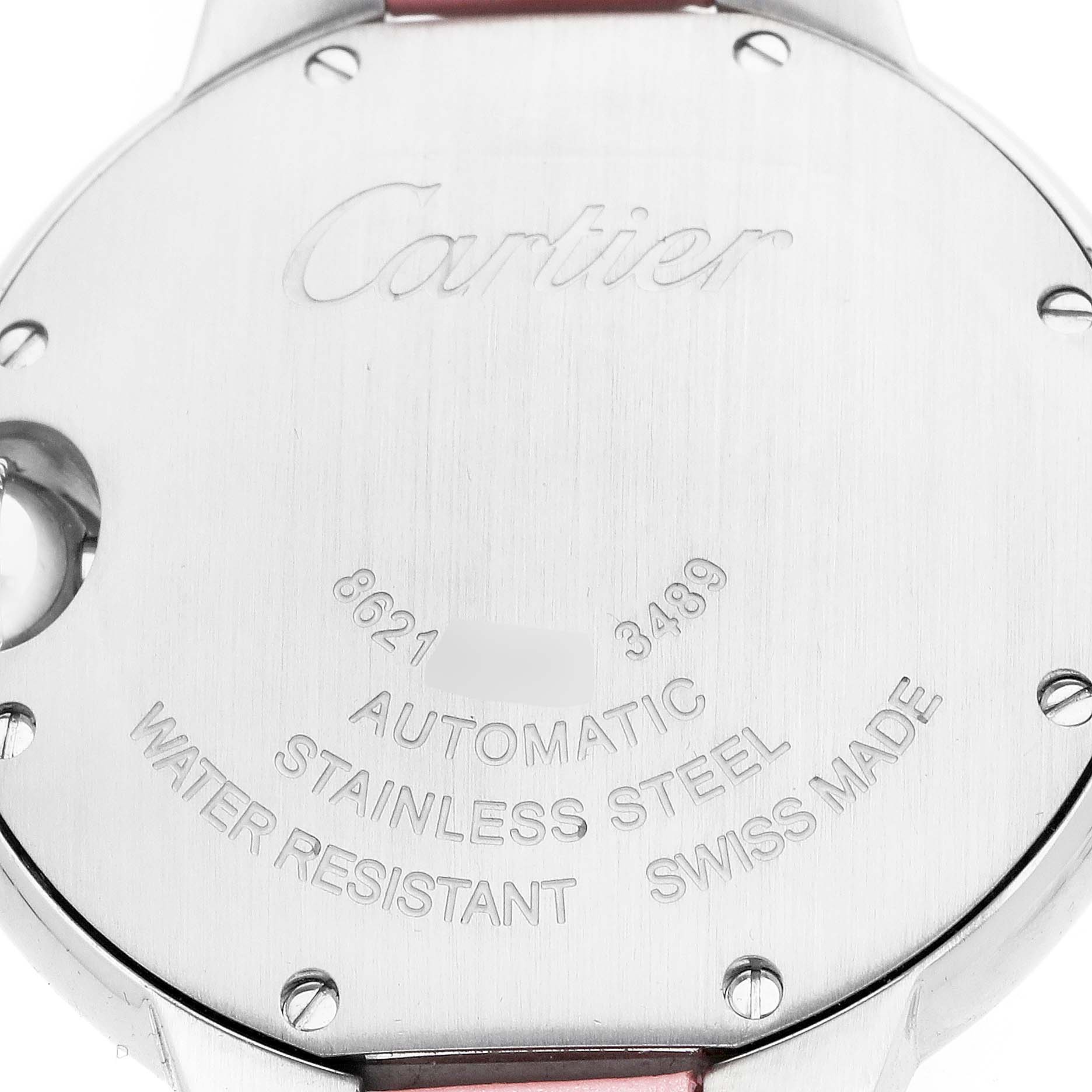 The image shows the back of a Cartier Ballon Bleu WSBB0002 Women
s Stainless Steel Pink Dial watch focusing on the engraved details and material.