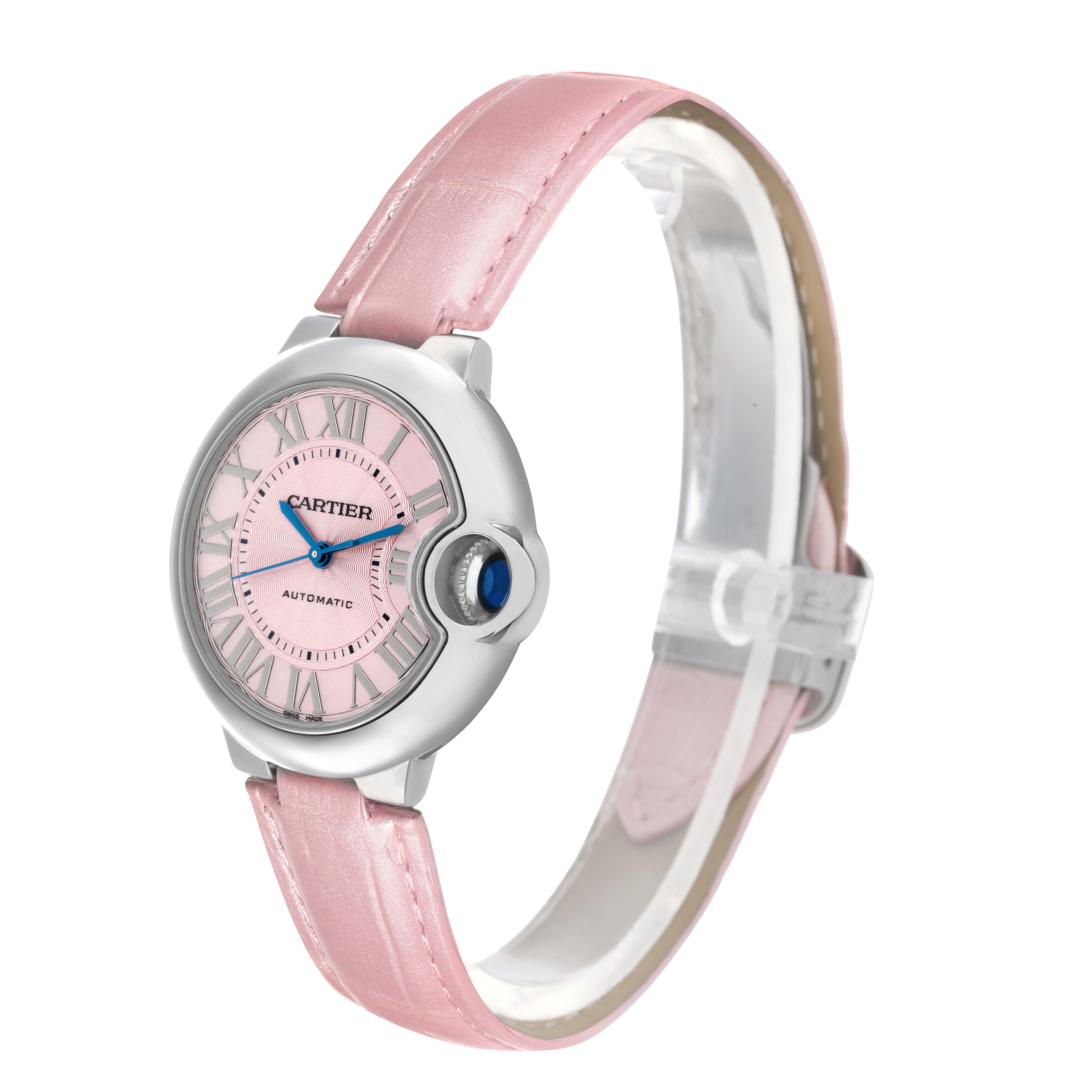 The Cartier Ballon Bleu WSBB0002 Women
s Stainless Steel Pink Dial watch is shown from a front-side angle, highlighting its pink strap and blue cabochon crown.