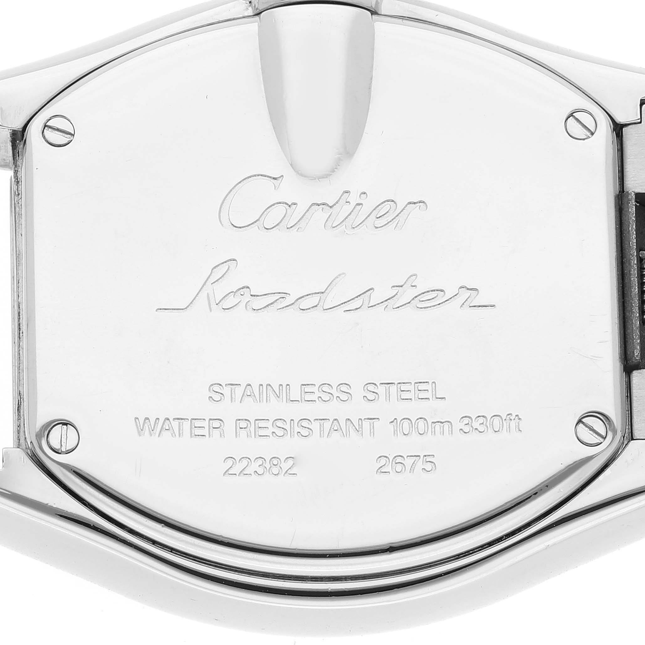 This image shows the backside of the Roadster watch by Cartier, highlighting its stainless steel, water resistance, and serial numbers.