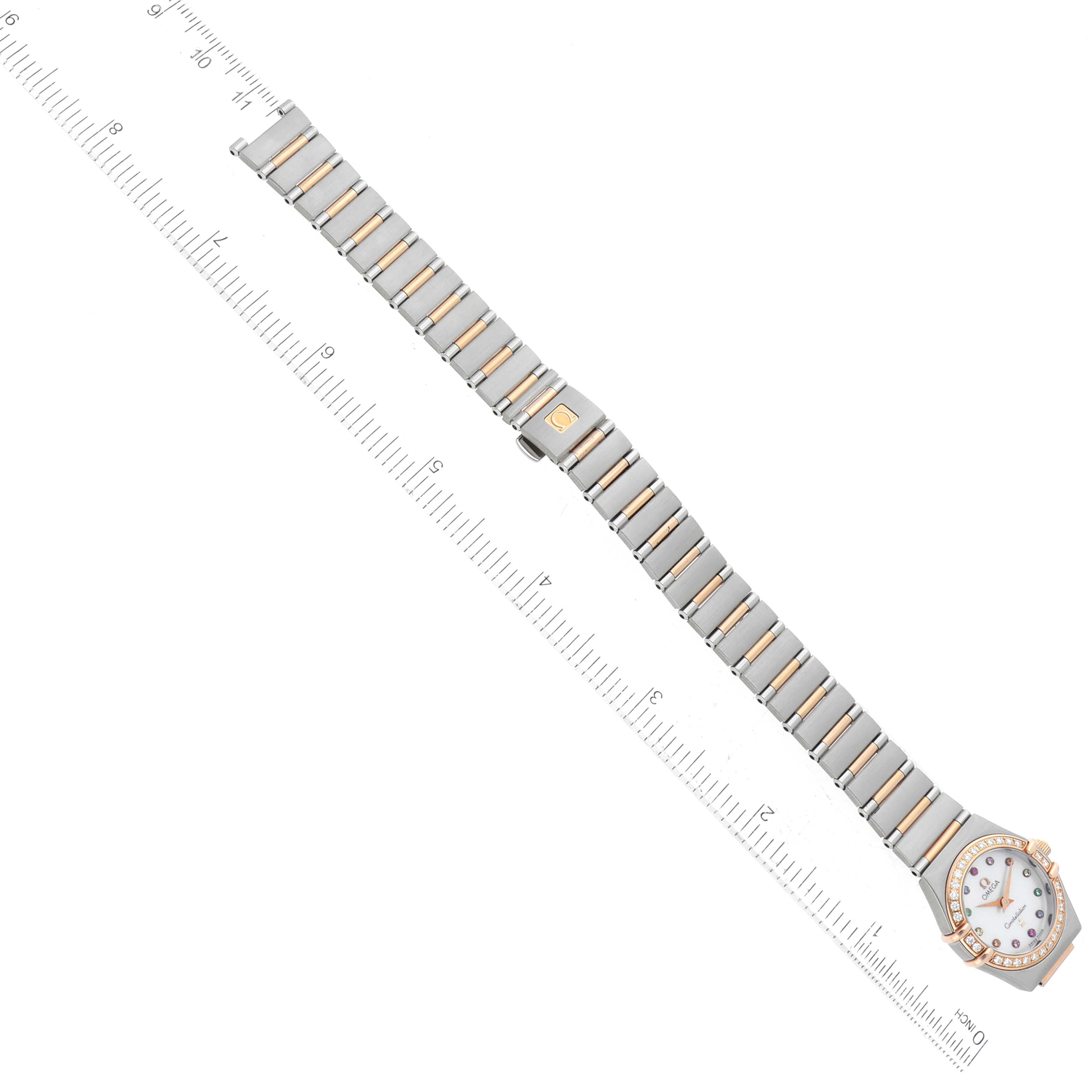 The image shows the Omega 1360.79.00 Women's Steel and Gold (two tone) Mother of Pearl Dial 1360.79.00 Women's Steel and Gold (two tone) Mother of Pearl Dial Constellation Steel Rose Gold Mother of Pearl Diamond Ladies Watch 1360.79.00 laid flat with a ruler.