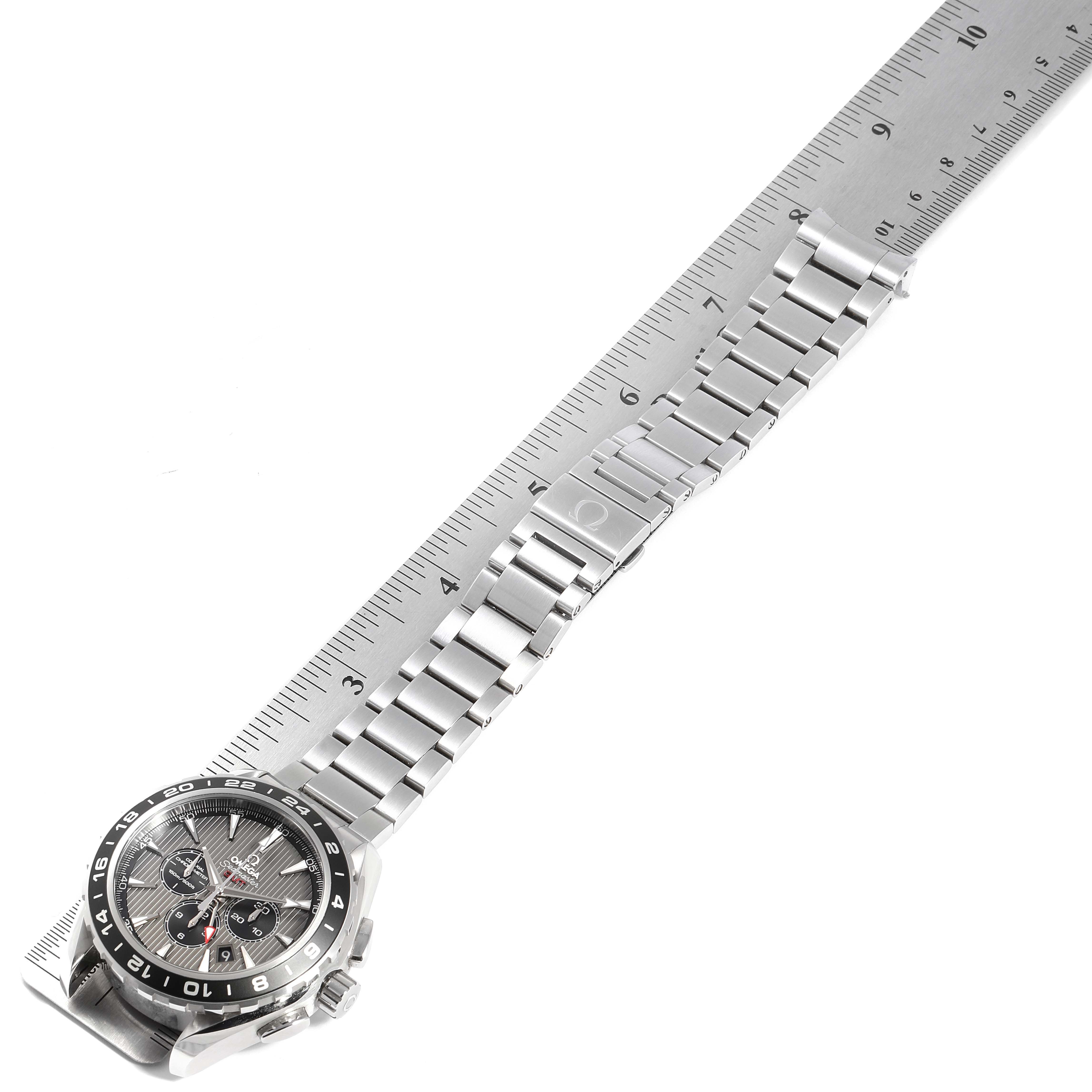 The Omega Aqua Terra 231.10.44.52.06.001 Men's Stainless Steel Grey Dial 231.10.44.52.06.001 Men's Stainless Steel Grey Dial watch is shown from a slightly tilted angle, highlighting its dial, bezel, and metal bracelet alongside a ruler for scale.