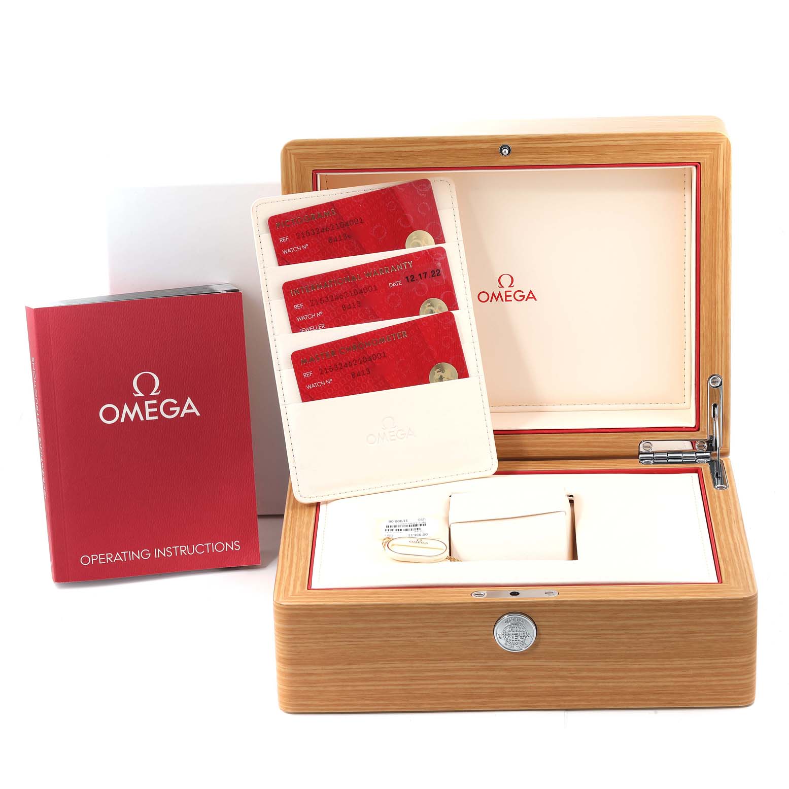 The image shows the packaging and accessories of the Omega Planet Ocean 215.32.46.21.04.001 Men's Stainless Steel White Dial 215.32.46.21.04.001 Men's Stainless Steel White Dial watch, including a wooden watch box, warranty cards, and an operating manual.