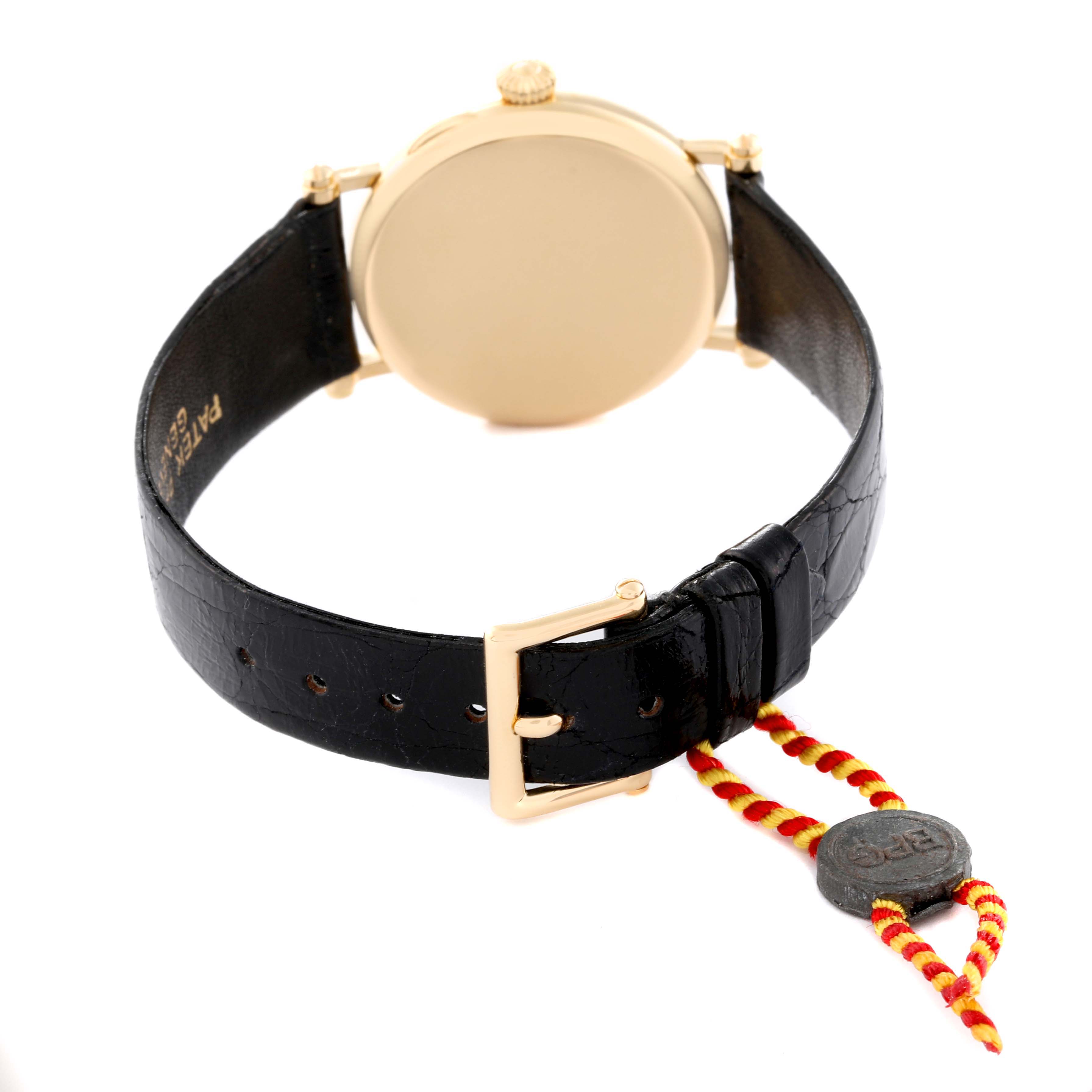 This image shows the rear view of a Patek Philippe Calatrava 3960 Men's Yellow Gold Silver Dial 3960 Men's Yellow Gold Silver Dial watch, highlighting the black leather strap and gold buckle.