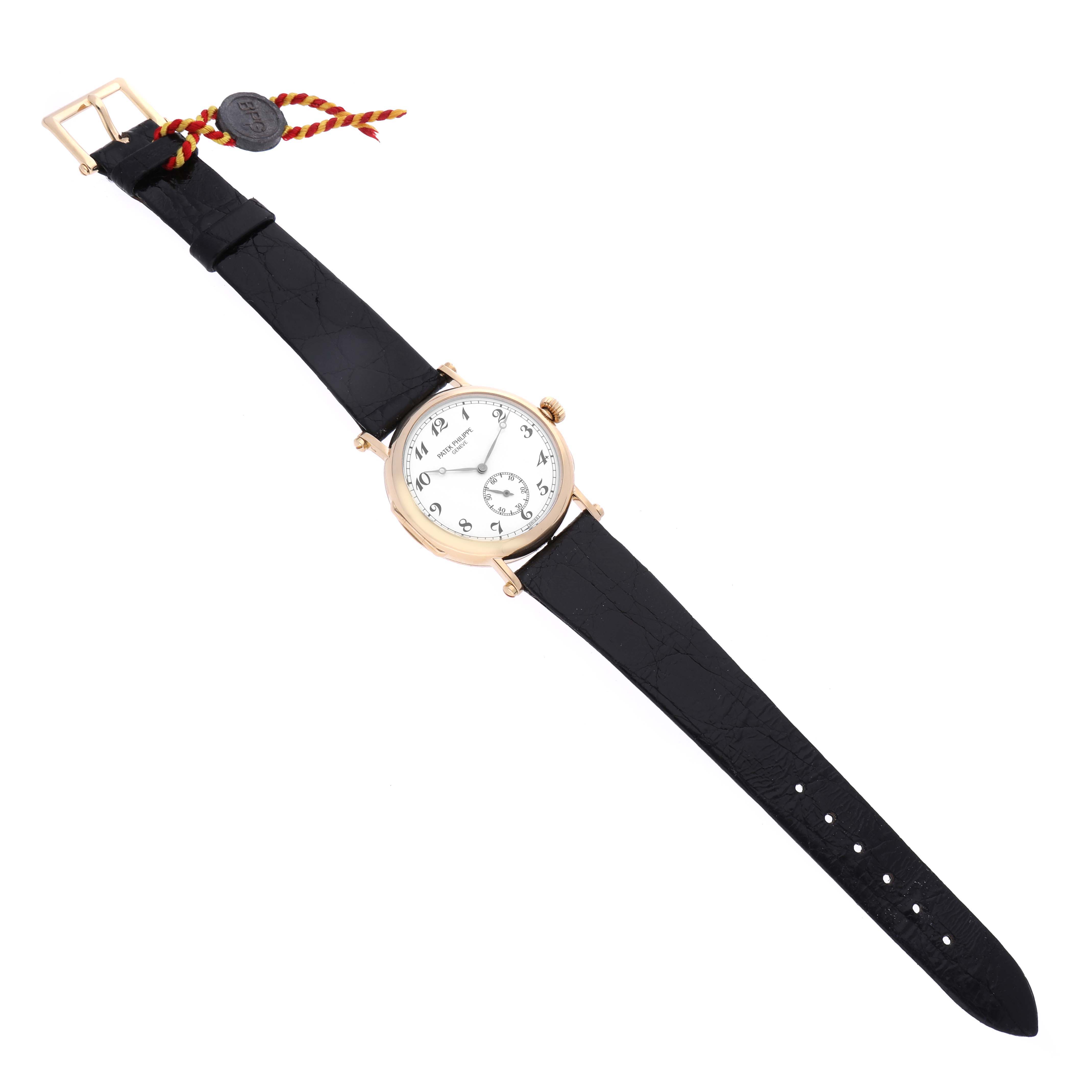 The image shows a Patek Philippe Calatrava 3960 Men's Yellow Gold Silver Dial 3960 Men's Yellow Gold Silver Dial watch from a top-down angle, featuring its black leather strap, white dial, and gold case.