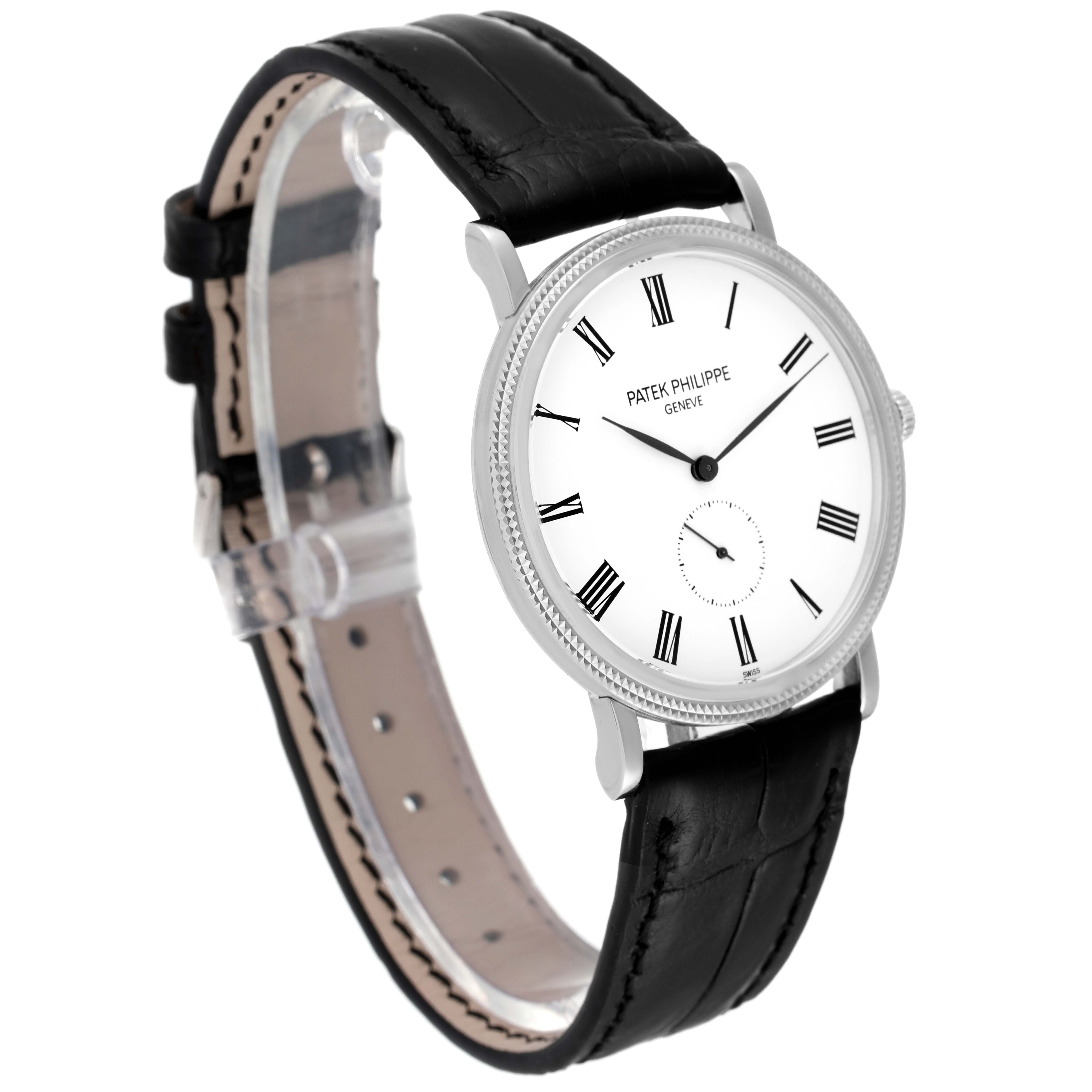 This image shows a Patek Philippe Calatrava 5119 Men's White Gold White Dial 5119 Men's White Gold White Dial watch from an angled side view, featuring its face, bezel, and black leather strap.