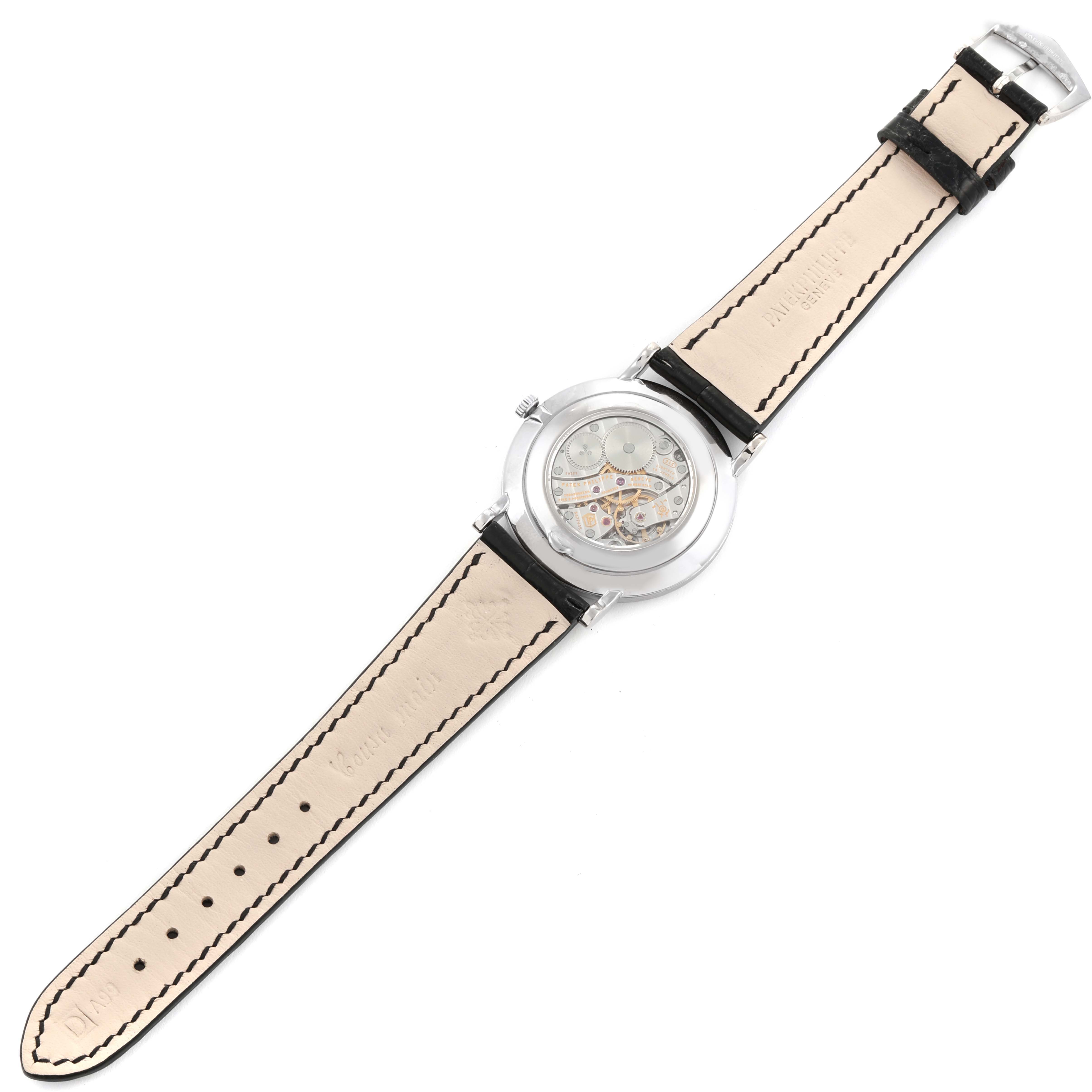 The image shows the back view of a Patek Philippe Calatrava 5119 Men's White Gold White Dial 5119 Men's White Gold White Dial watch, highlighting its mechanical movement and leather strap.