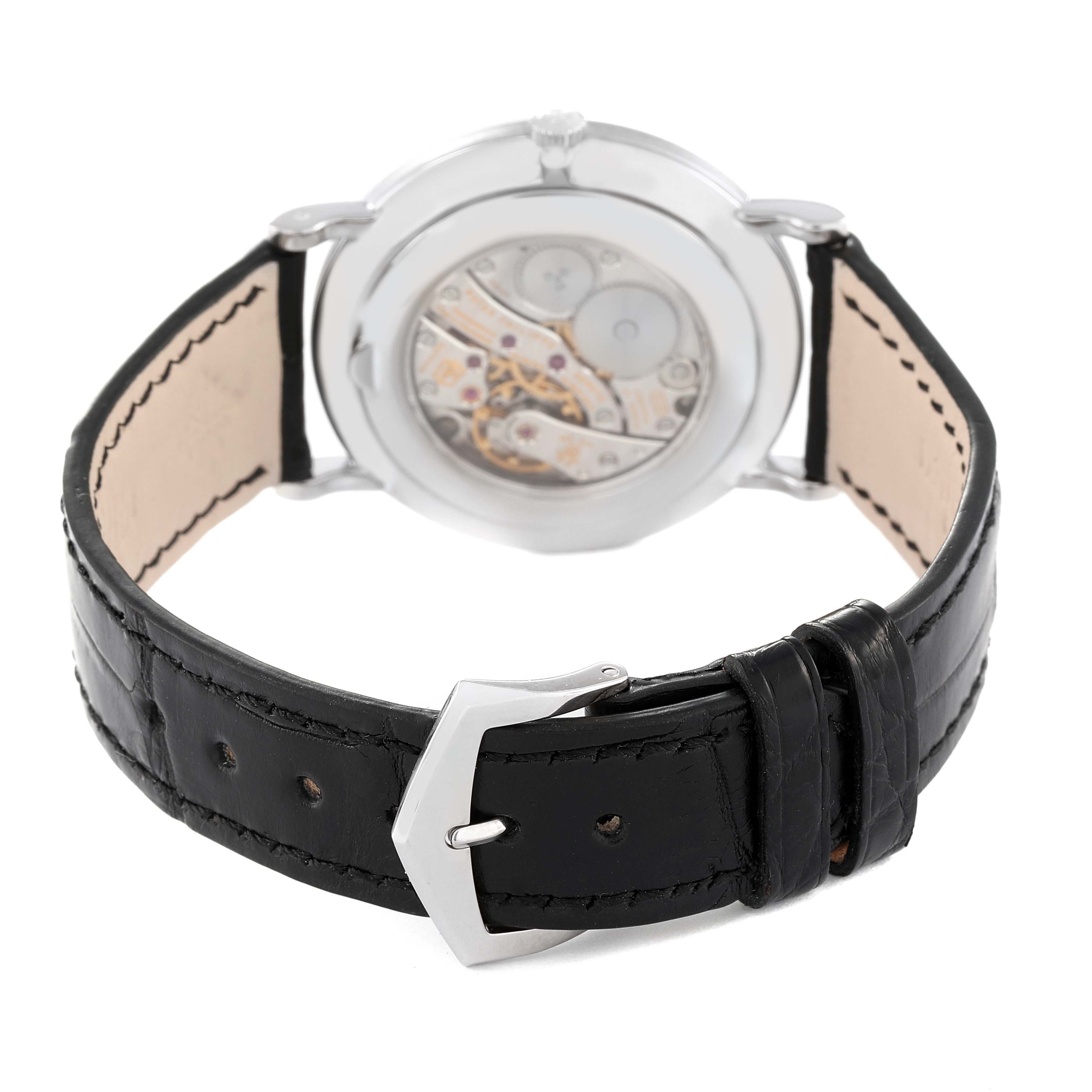 The image shows the backside and strap of the Calatrava watch by Patek Philippe, highlighting its transparent case back and leather strap.