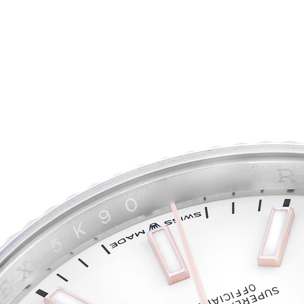 The image shows a close-up of the bezel, part of the dial, and hour markers of a Rolex Datejust 126231 Men's Steel and Gold (two tone) White Dial watch.