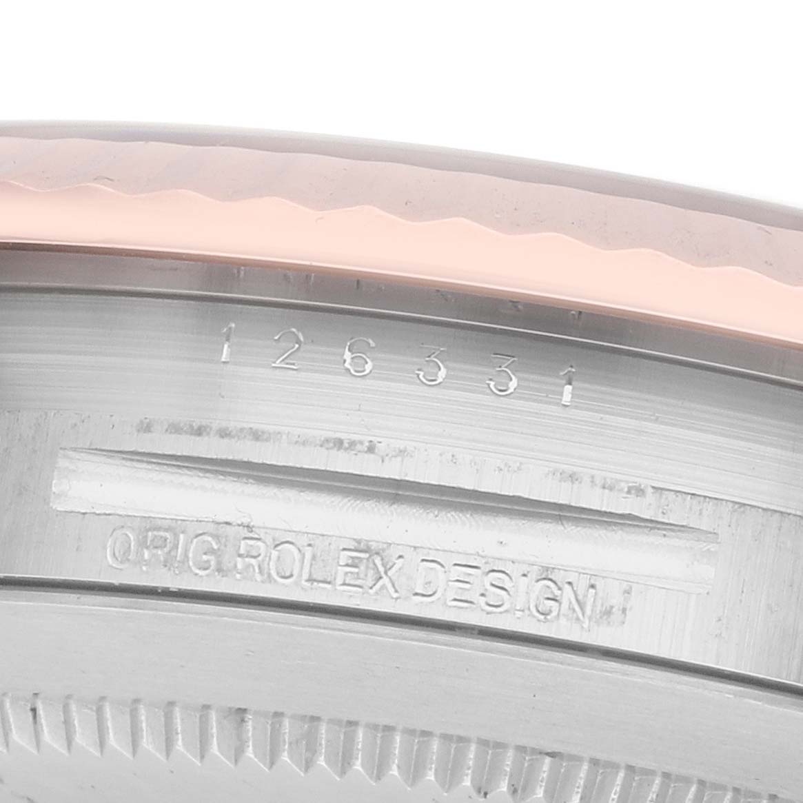 The image shows a close-up of the Rolex Datejust 41 126331 Men
s Steel and Gold (two tone) Brown Dial model
s case, highlighting the serial number and "ORIG ROLEX DESIGN" engraving.