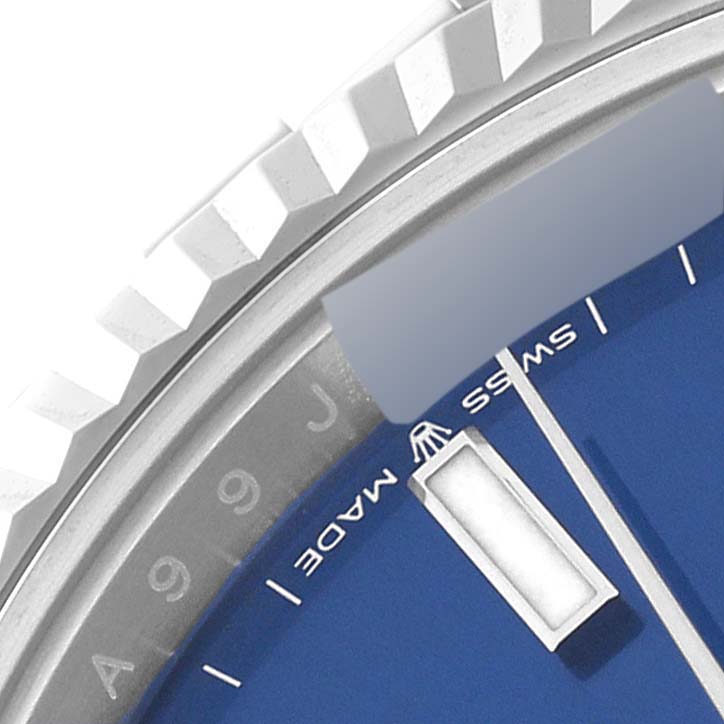 This close-up angle shows the fluted bezel, part of the blue dial, and "Swiss Made" text of a Rolex Datejust 41 126334 Men
s Stainless Steel Blue Dial 126334 Men
s Stainless Steel Blue Dial.