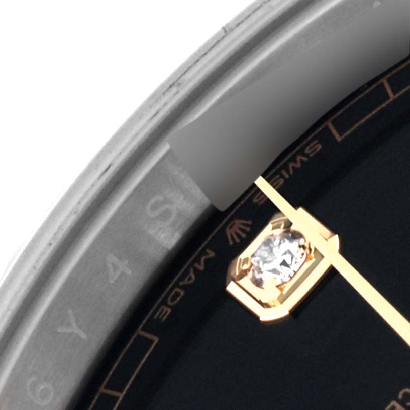 This close-up image of the Rolex Datejust 41 126333 Men's Steel and Gold (two tone) Black Dial 126333 Men's Steel and Gold (two tone) Black Dial shows part of the dial, a diamond marker, and the edge of the case.