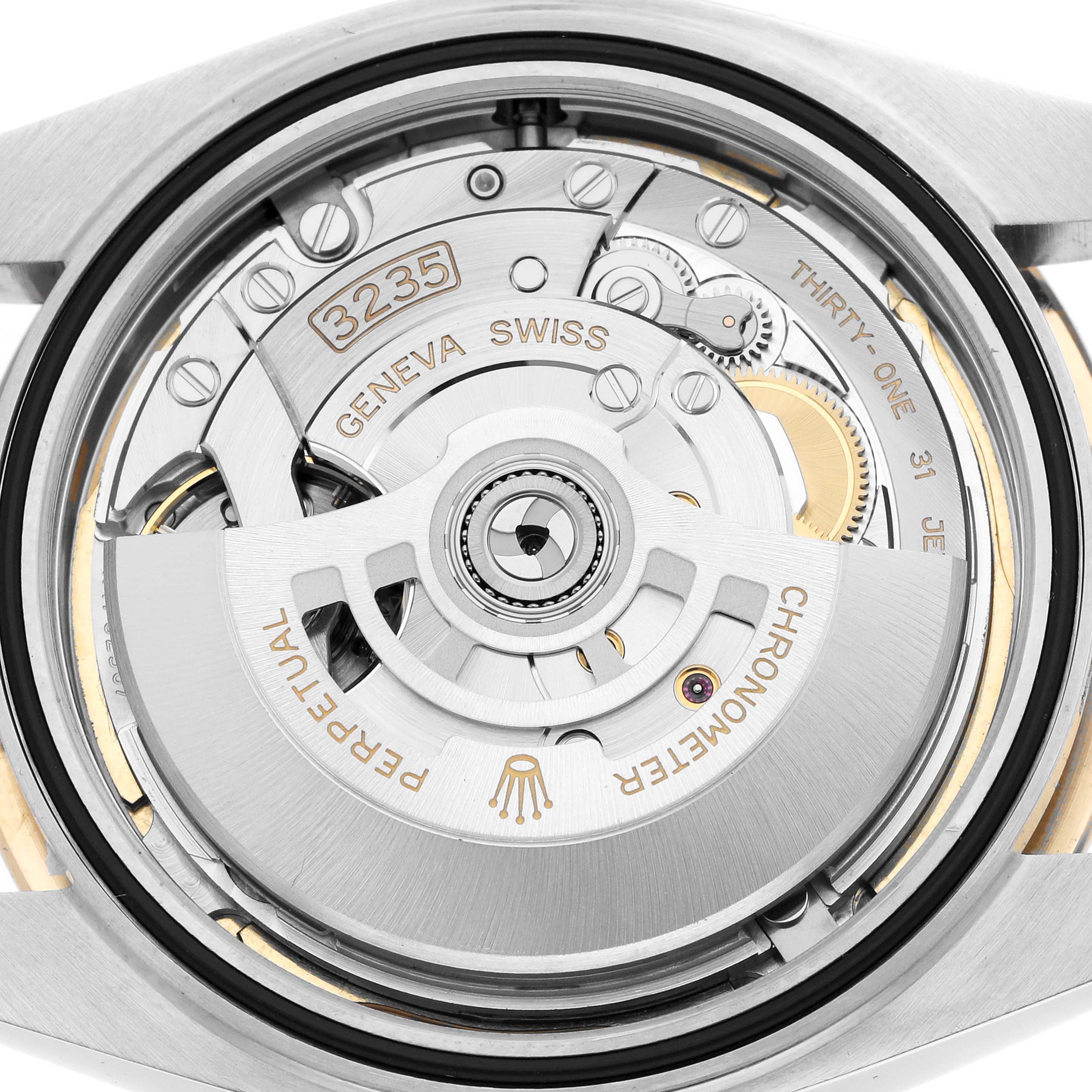 The image shows the movement of a Rolex Datejust 41 126303 Men
s Steel and Gold (two tone) Champagne Dial with a detailed view of the rotor and gears from the back.