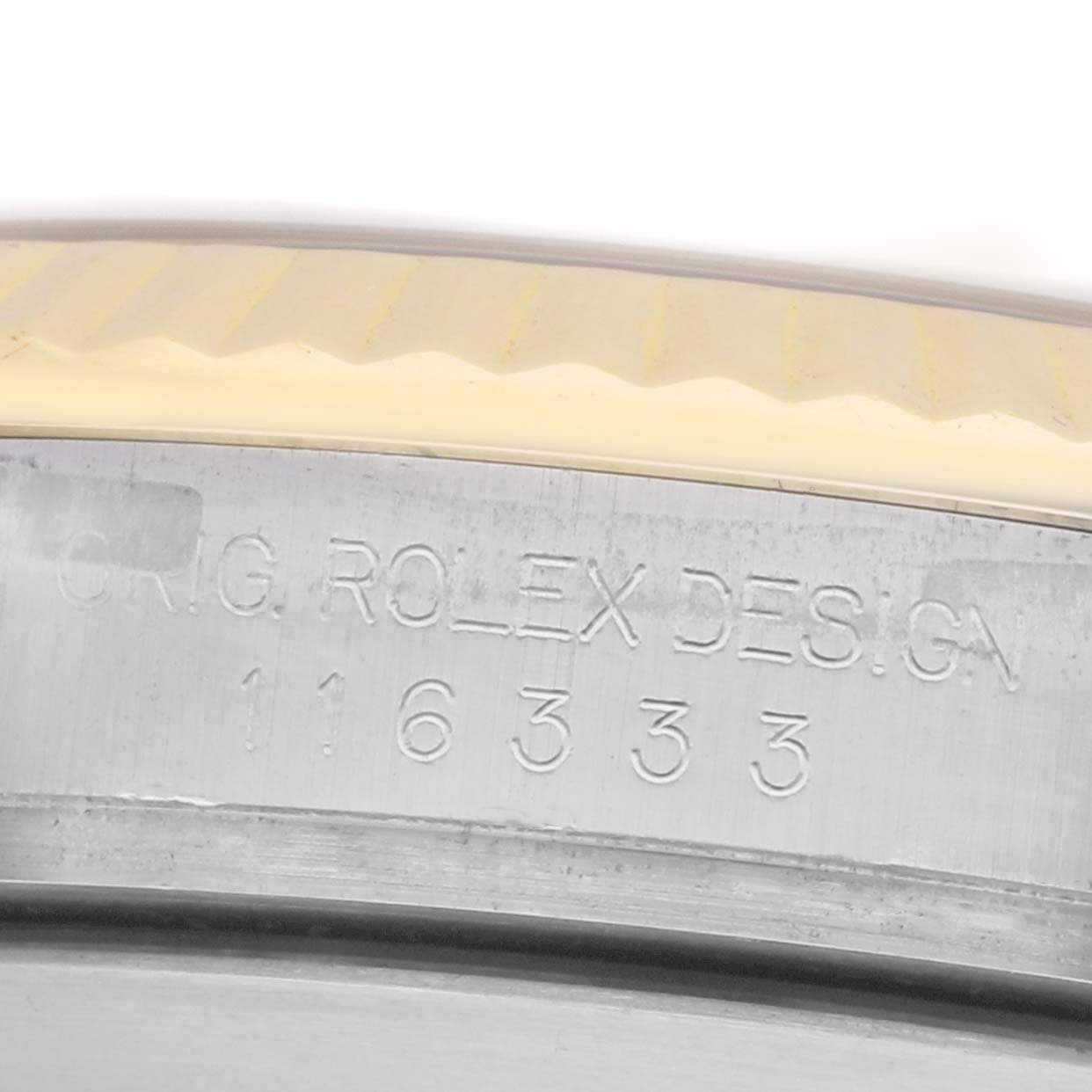 The image shows a close-up of the Rolex Datejust 41 116333 Men
s Steel and Gold (two tone) Black Dial model
s engraved side with part of the bezel.