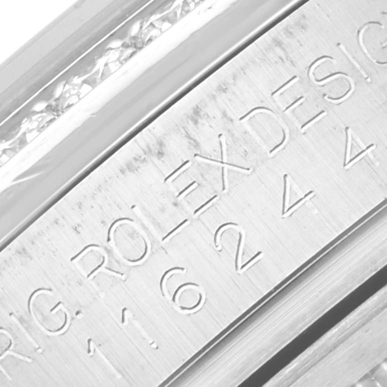 The image shows an engraved section of the bezel part of a Rolex Datejust 116244 Men's Steel and Gold (two tone) Pink Dial 116244 Men's Steel and Gold (two tone) Pink Dial watch.