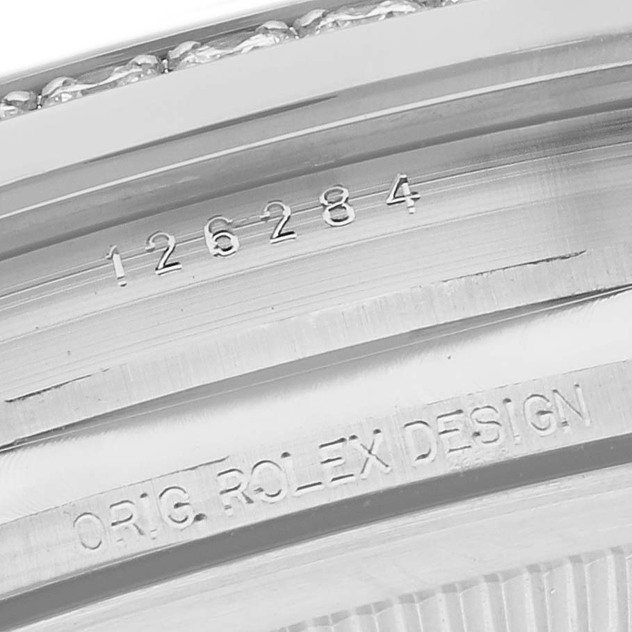 Close-up of the engraving inside the bezel of a Rolex Datejust 126284 Men's Stainless Steel Silver Dial 126284 Men's Stainless Steel Silver Dial watch, showing the model number and "ORIG. ROLEX DESIGN."