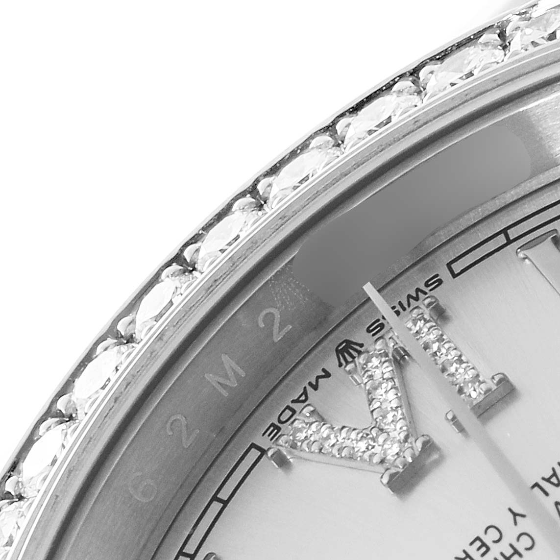 This close-up angle of the Rolex Datejust 126284 Men's Stainless Steel Silver Dial 126284 Men's Stainless Steel Silver Dial shows part of the jeweled bezel and dial, including the "Swiss Made" label.