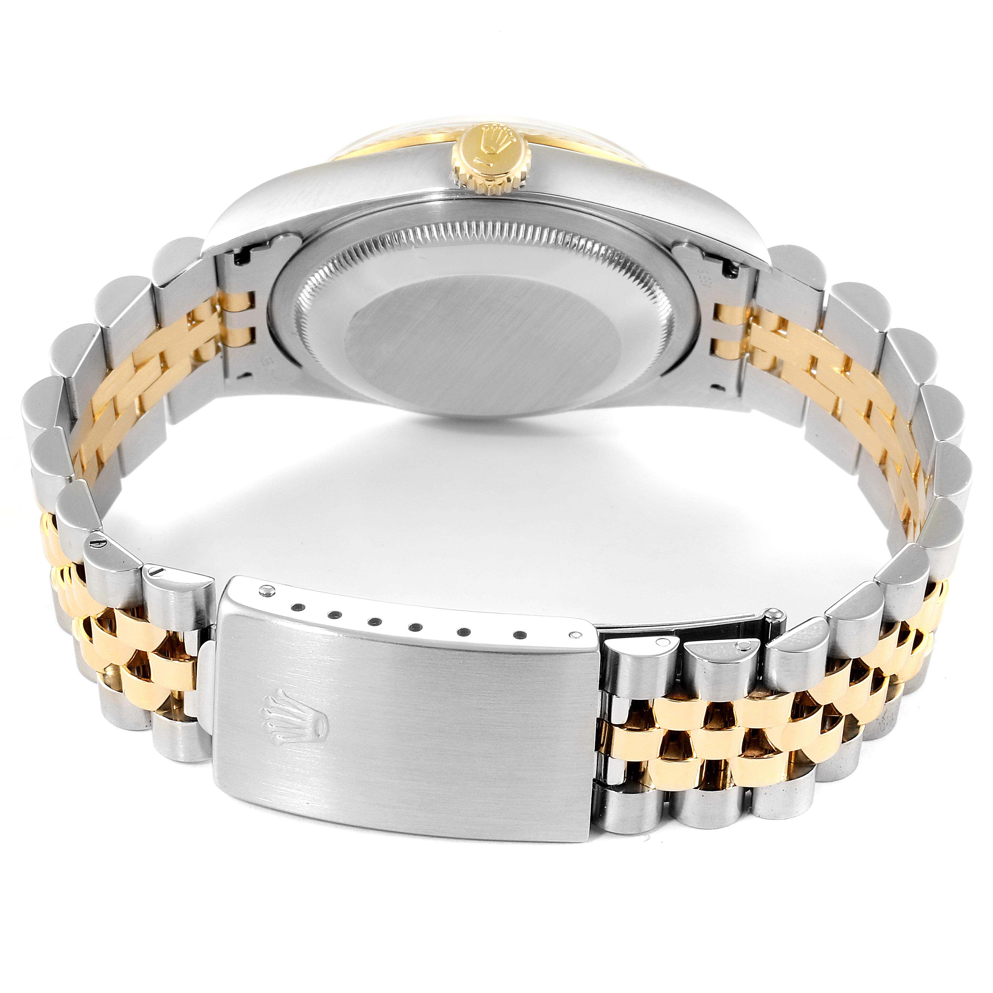 The image shows the back view of a Rolex Datejust 16233 Men
s Steel and Gold (two tone) Champagne Dial 16233 Men
s Steel and Gold (two tone) Champagne Dial watch, highlighting the clasp, bracelet, and caseback.