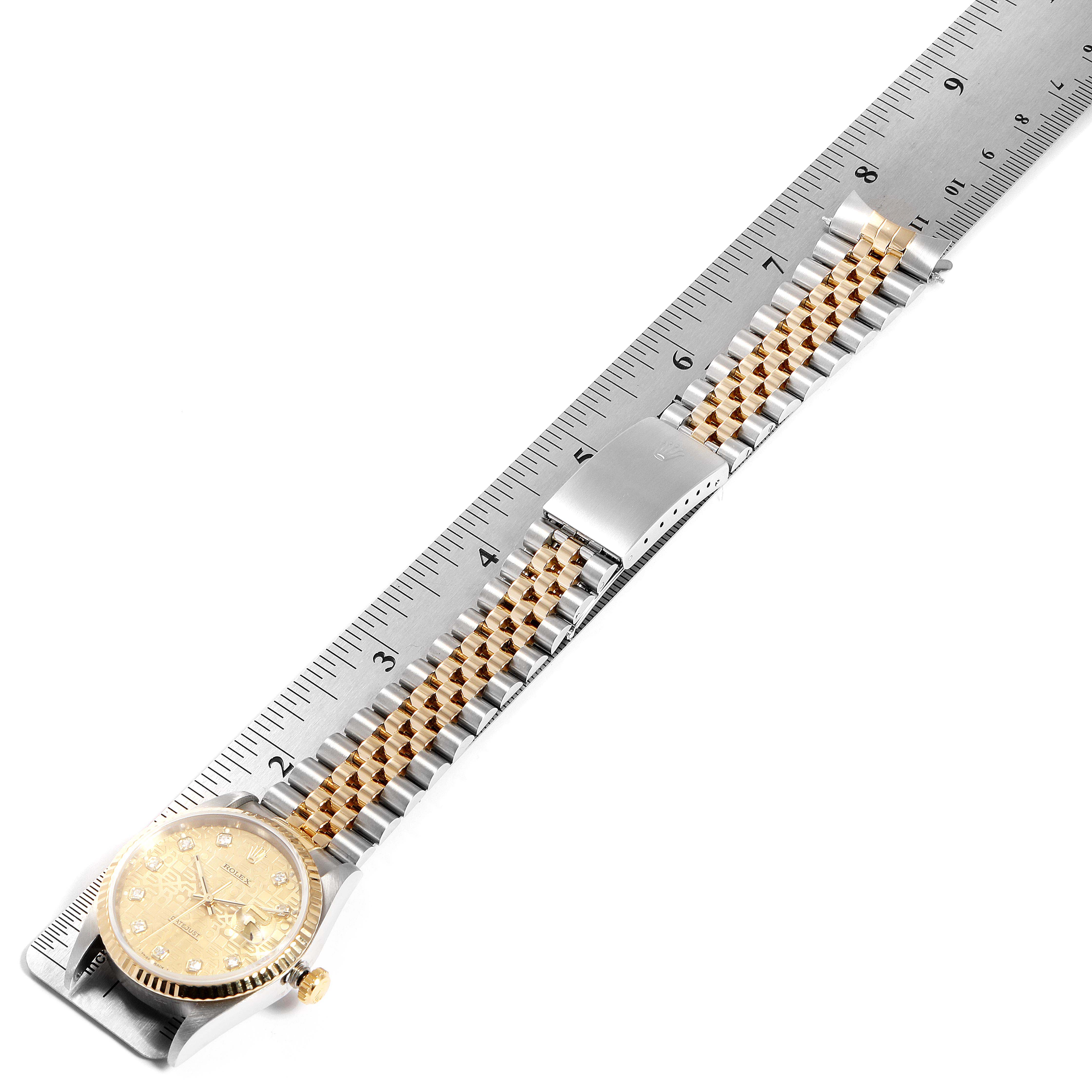 The image shows a Rolex Datejust 16233 Men
s Steel and Gold (two tone) Champagne Dial 16233 Men
s Steel and Gold (two tone) Champagne Dial watch laying flat with both the face and the jubilee bracelet visible against a ruler for size reference.