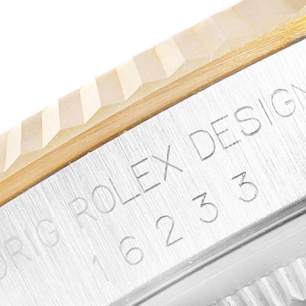 The image shows a close-up of the bezel and case edge with the engraved text on a Rolex Datejust 16233 Men
s Steel and Gold (two tone) Champagne Dial 16233 Men
s Steel and Gold (two tone) Champagne Dial model.