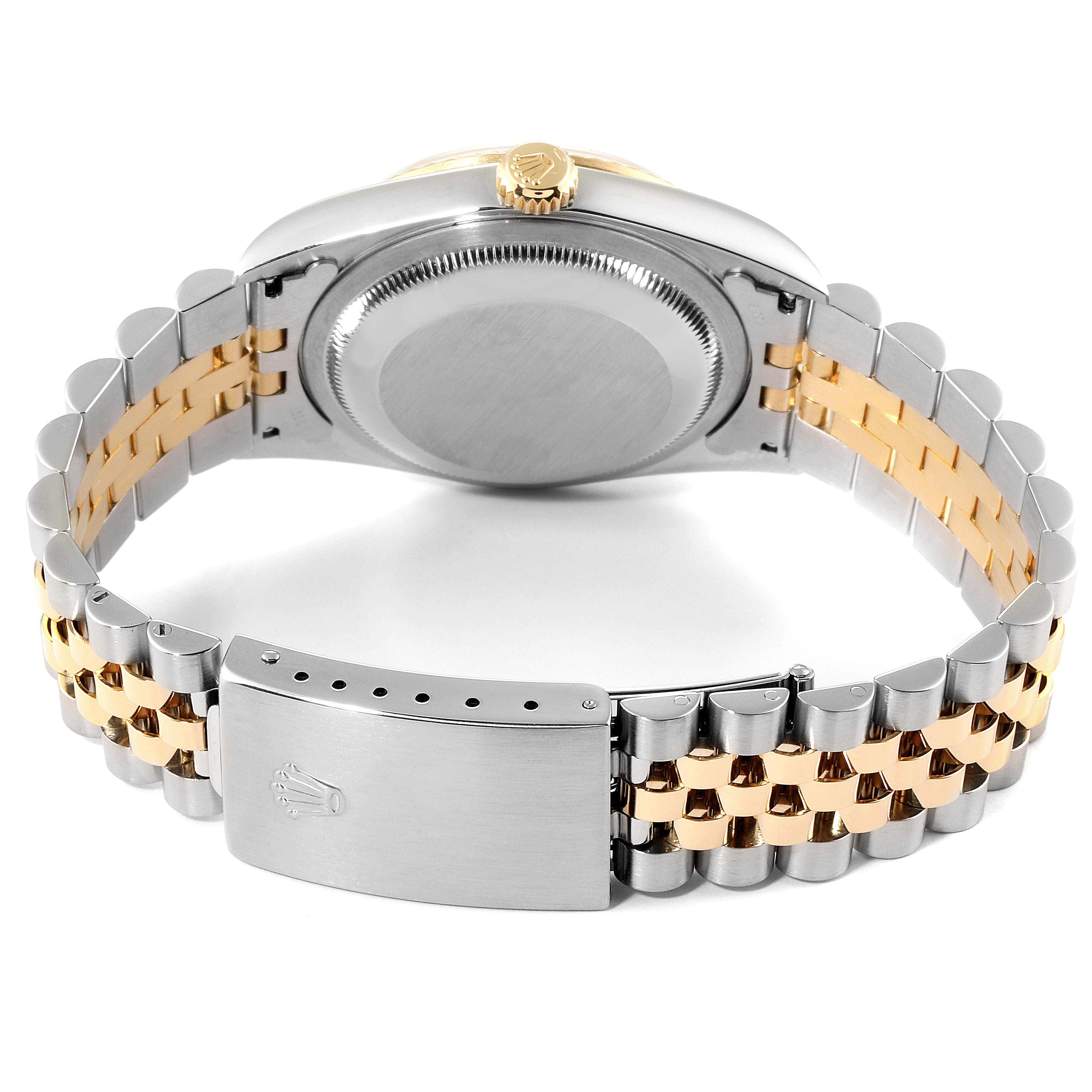 The image shows the underside view of a Rolex Datejust 16233 Men
s Steel and Gold (two tone) Champagne Dial 16233 Men
s Steel and Gold (two tone) Champagne Dial watch, focusing on the case back and the jubilee bracelet with a clasp.