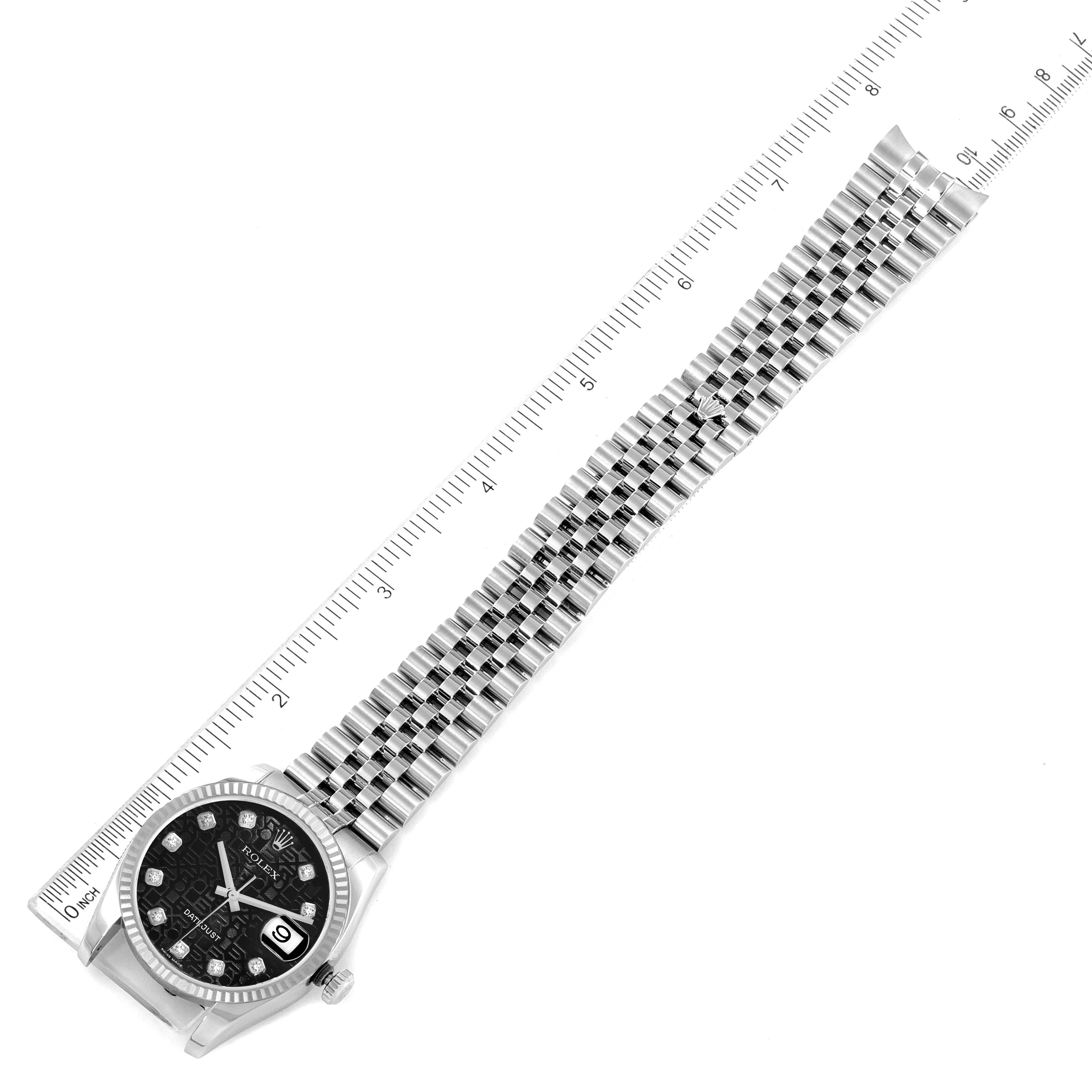The Rolex Datejust 16234 Men
s Stainless Steel Black Dial watch is shown from an overhead angle, displaying the face, bezel, and full bracelet alongside a ruler.