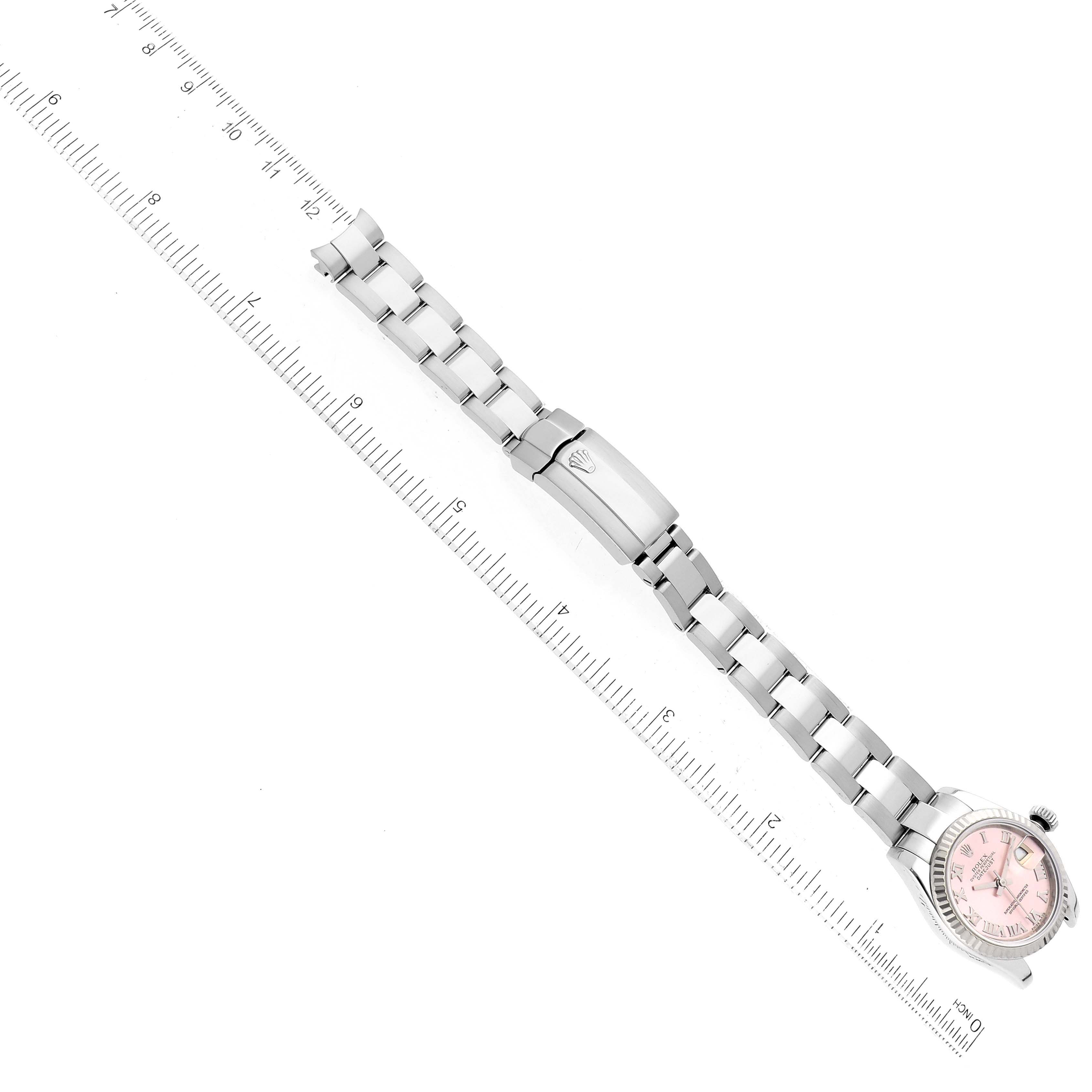 The image shows a side view of the Rolex Datejust 179174 Women's Stainless Steel Pink Dial 179174 Women's Stainless Steel Pink Dial watch and bracelet, positioned diagonally with a ruler for scale.