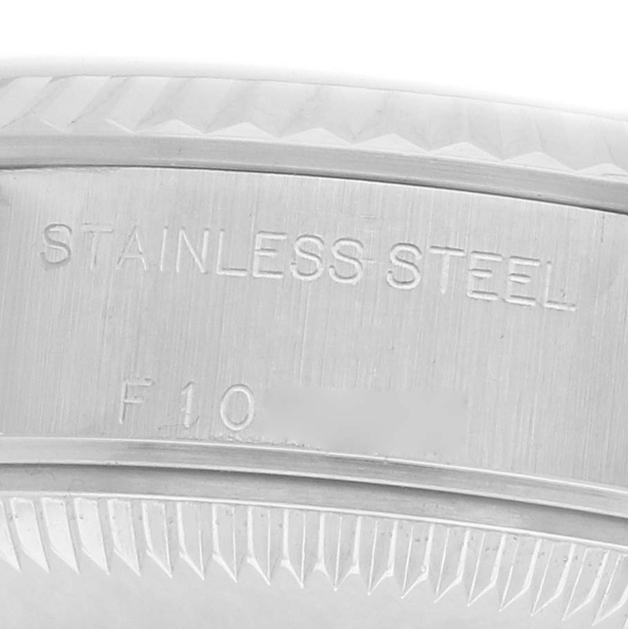 The image shows the side view of the bezel of a Rolex Datejust 79174 Women's Stainless Steel Blue Dial watch, highlighting the "STAINLESS STEEL" engraving.