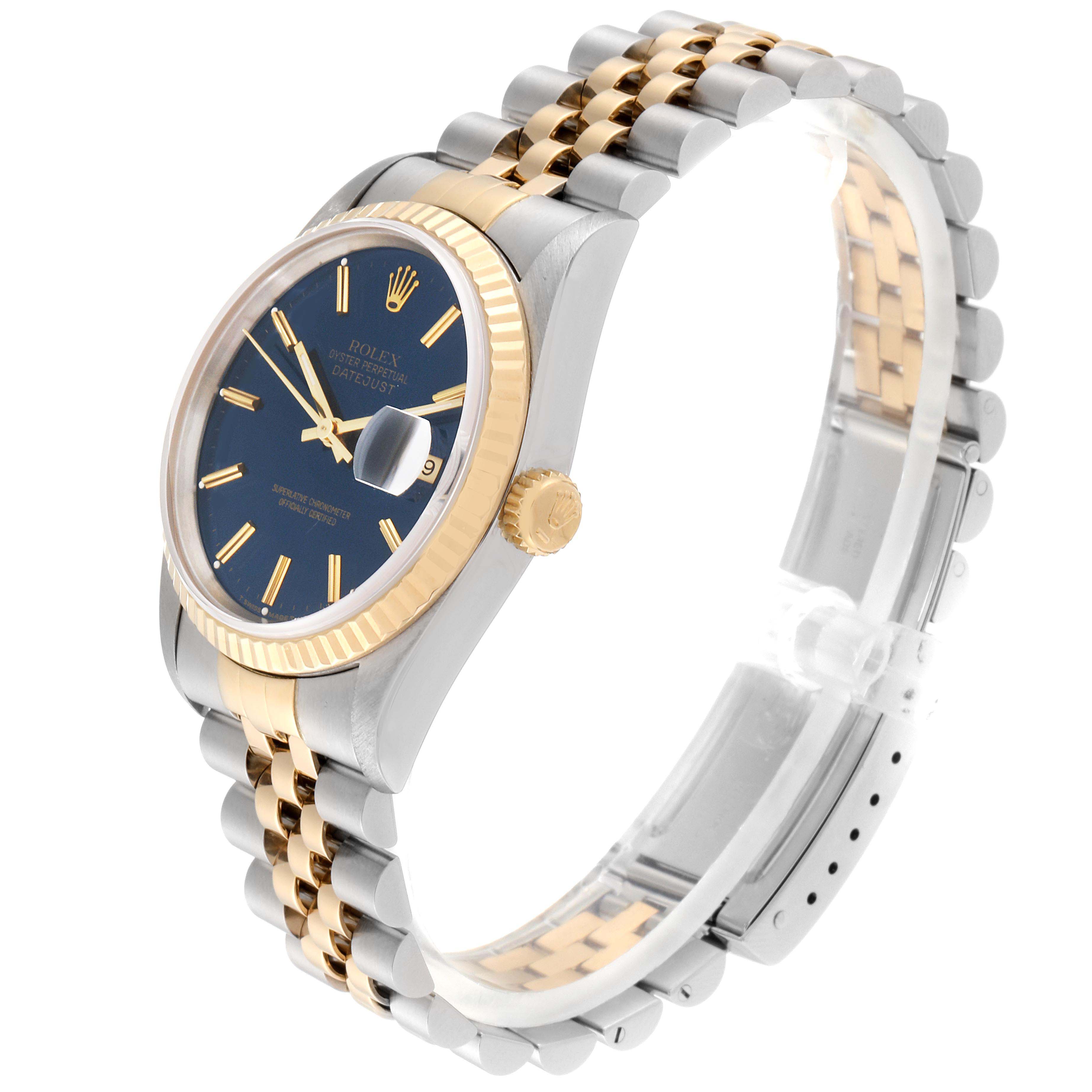 This Rolex Datejust 16233 Men's Steel and Gold (two tone) Blue Dial 16233 Men's Steel and Gold (two tone) Blue Dial watch is shown at an angled side view, displaying the band, crown, and face.