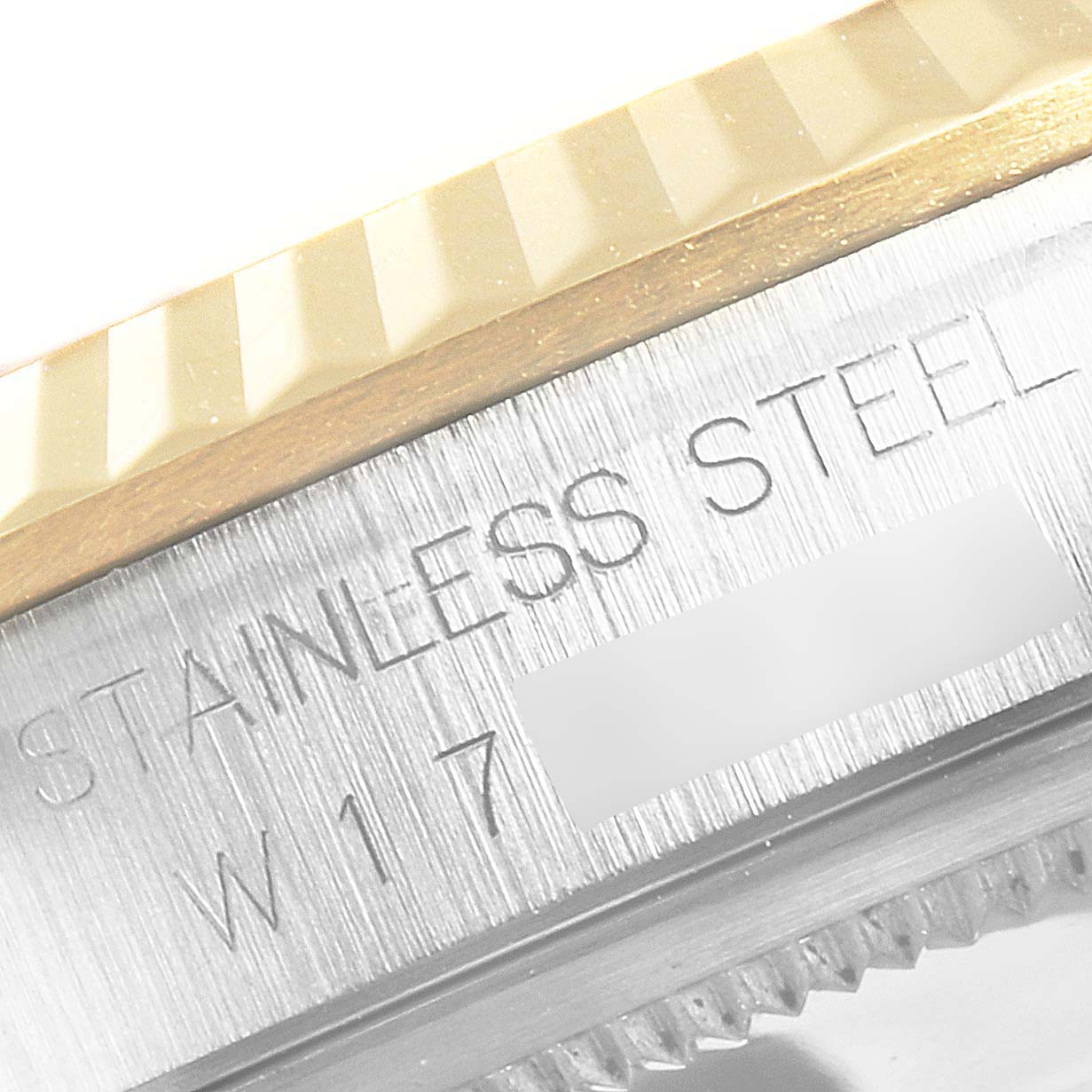 This is a close-up view of the side engraving and fluted bezel of a Datejust model by Rolex.