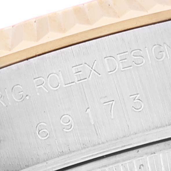 The image shows a close-up of the serial number engraving on the side of a Rolex Datejust 69173 Women's Steel and Gold (two tone) Champagne Dial 69173 Women's Steel and Gold (two tone) Champagne Dial watch case.