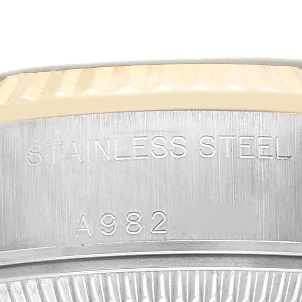 The image shows a close-up of the side of a Rolex Datejust 79173 Women's Steel and Gold (two tone) Champagne Dial, highlighting its stainless steel case and model number engraving.