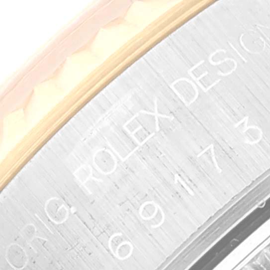 The image shows a close-up of the side of a Rolex Datejust 69173 Women's Steel and Gold (two tone) Champagne Dial 69173 Women's Steel and Gold (two tone) Champagne Dial watch, focusing on the engravings on the watch case.