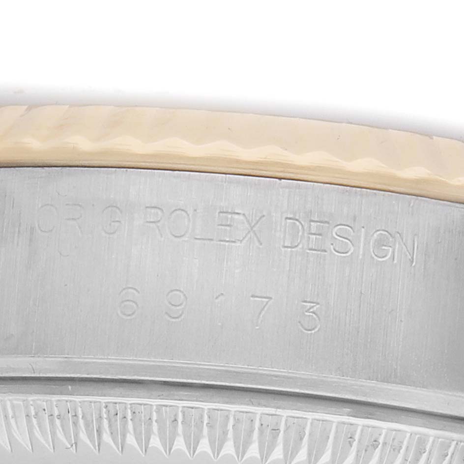 The image shows a close-up of a Rolex Datejust 69173 Women's Steel and Gold (two tone) Champagne Dial watch case, featuring its engraved design and model number.